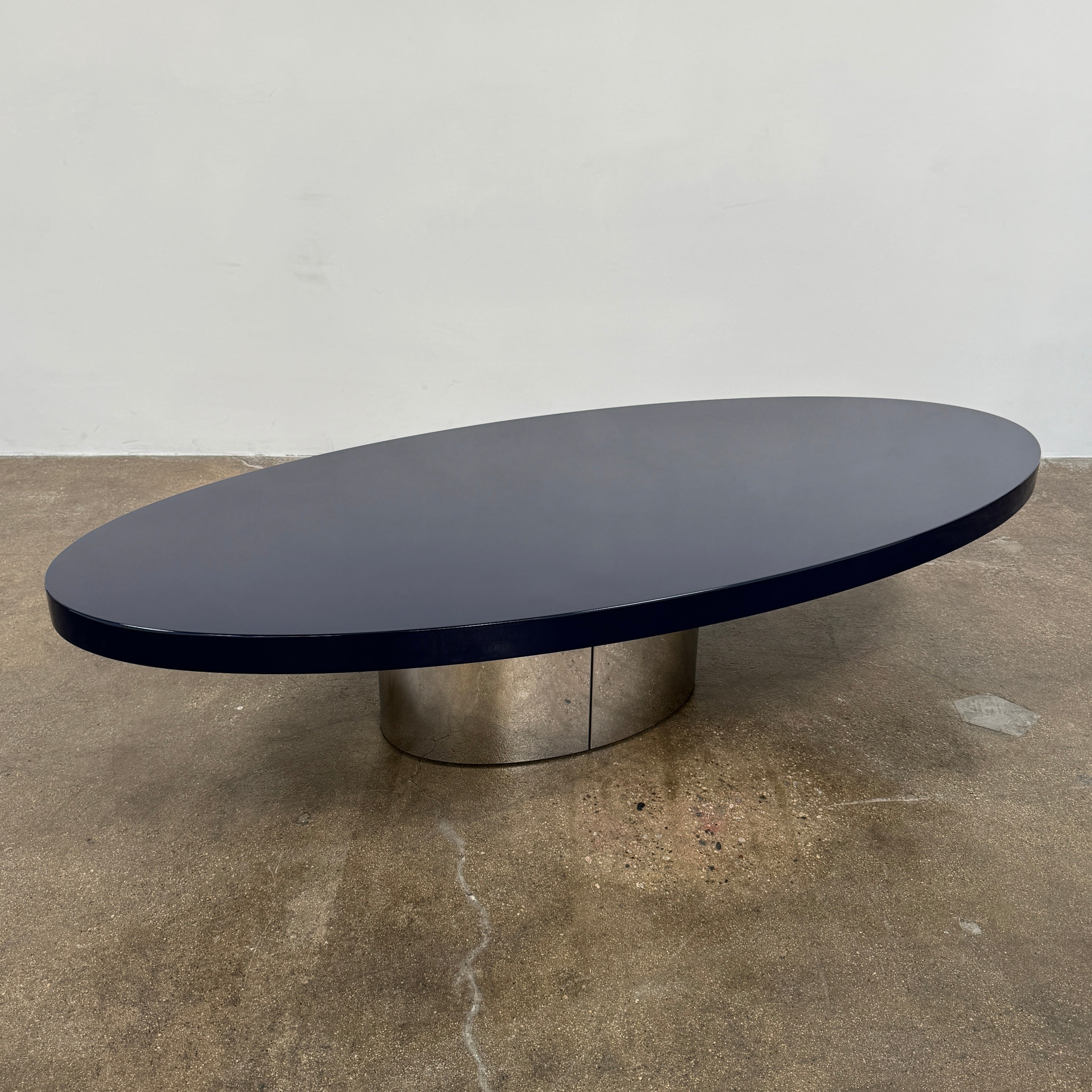 A sleek Minotti Raymond Coffee Table with a metal base, exhibiting clean shapes and proportions.