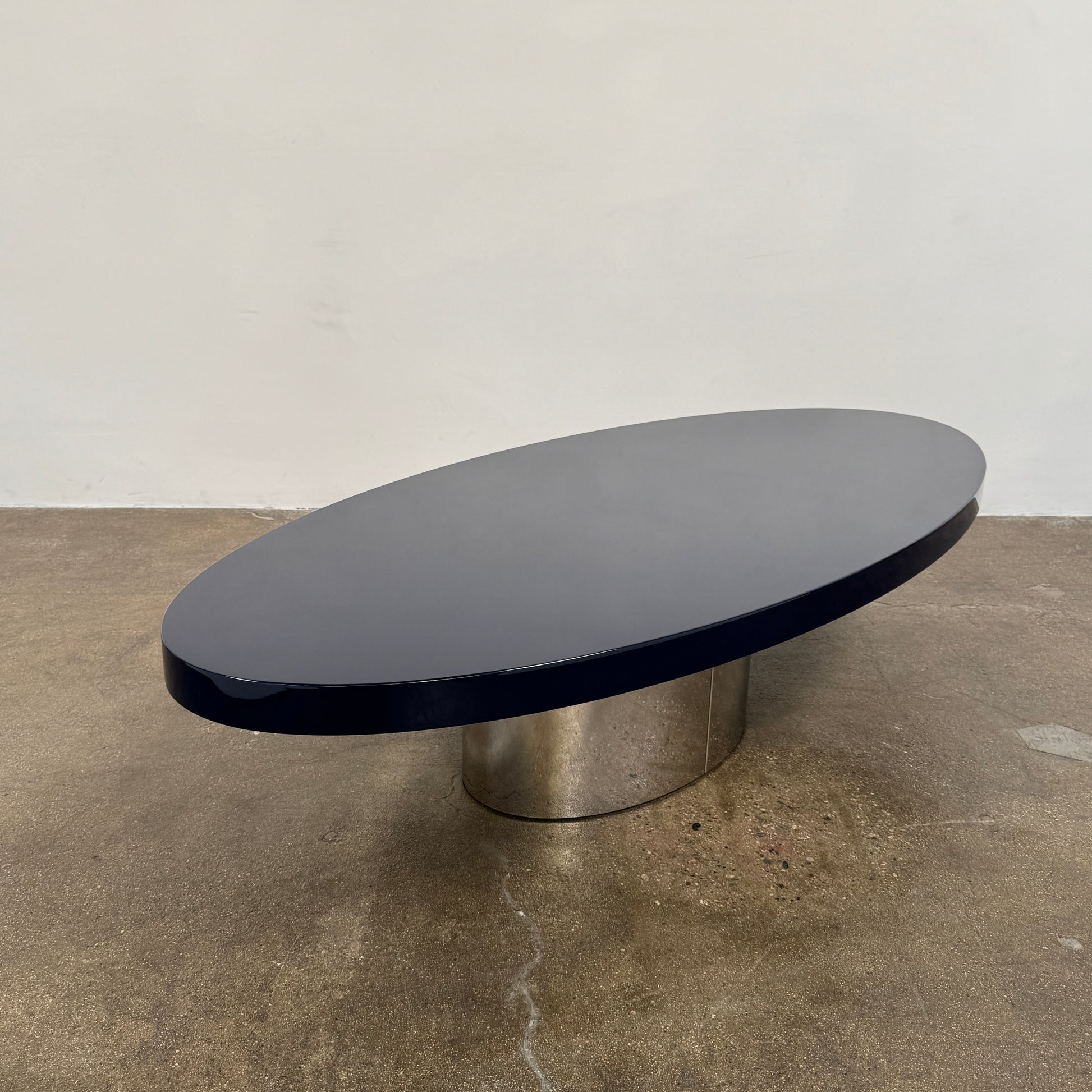 A sleek Minotti Raymond Coffee Table with a metal base, exhibiting clean shapes and proportions.