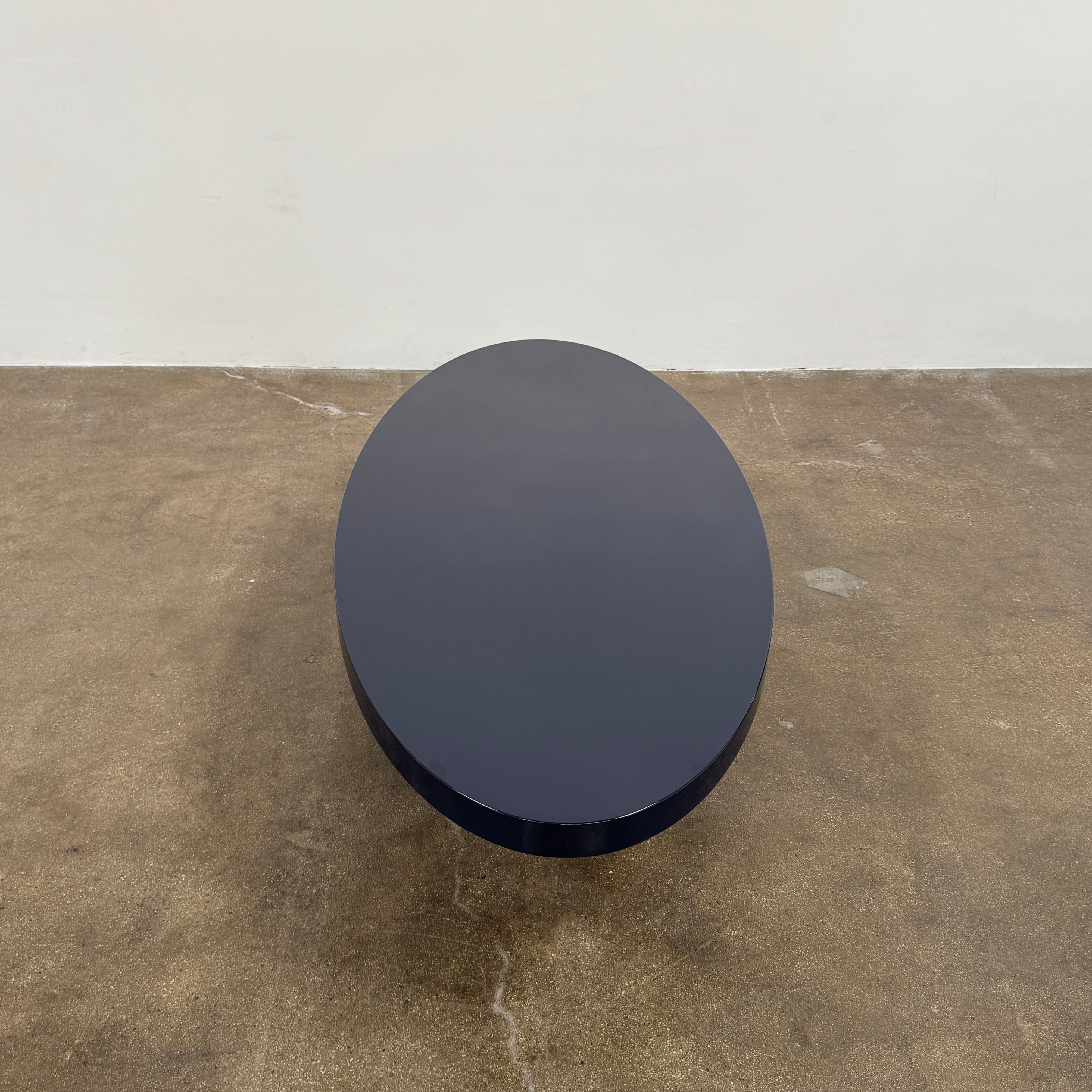 A sleek Minotti Raymond Coffee Table with a metal base, exhibiting clean shapes and proportions.