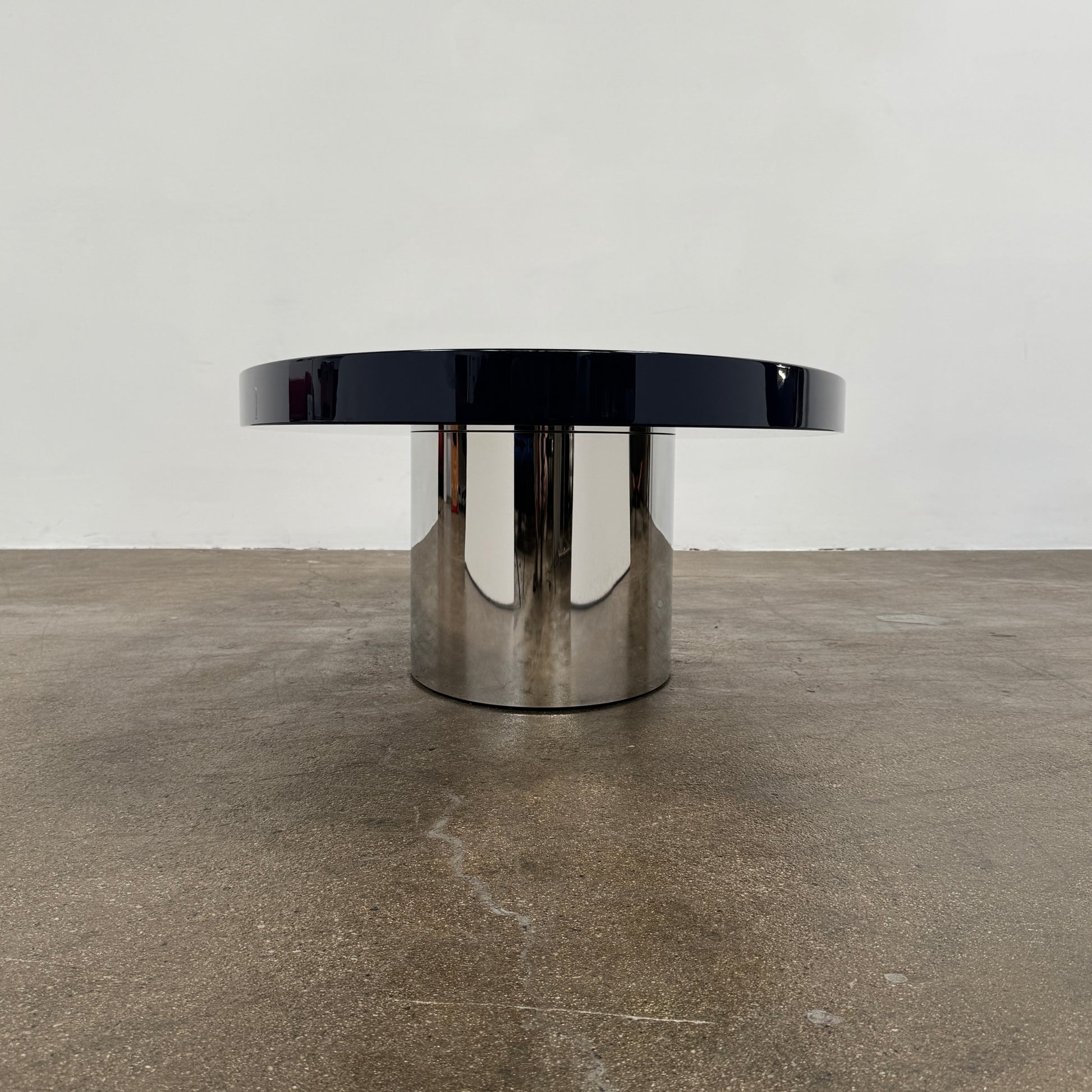 A sleek Minotti Raymond Coffee Table with a metal base, exhibiting clean shapes and proportions.