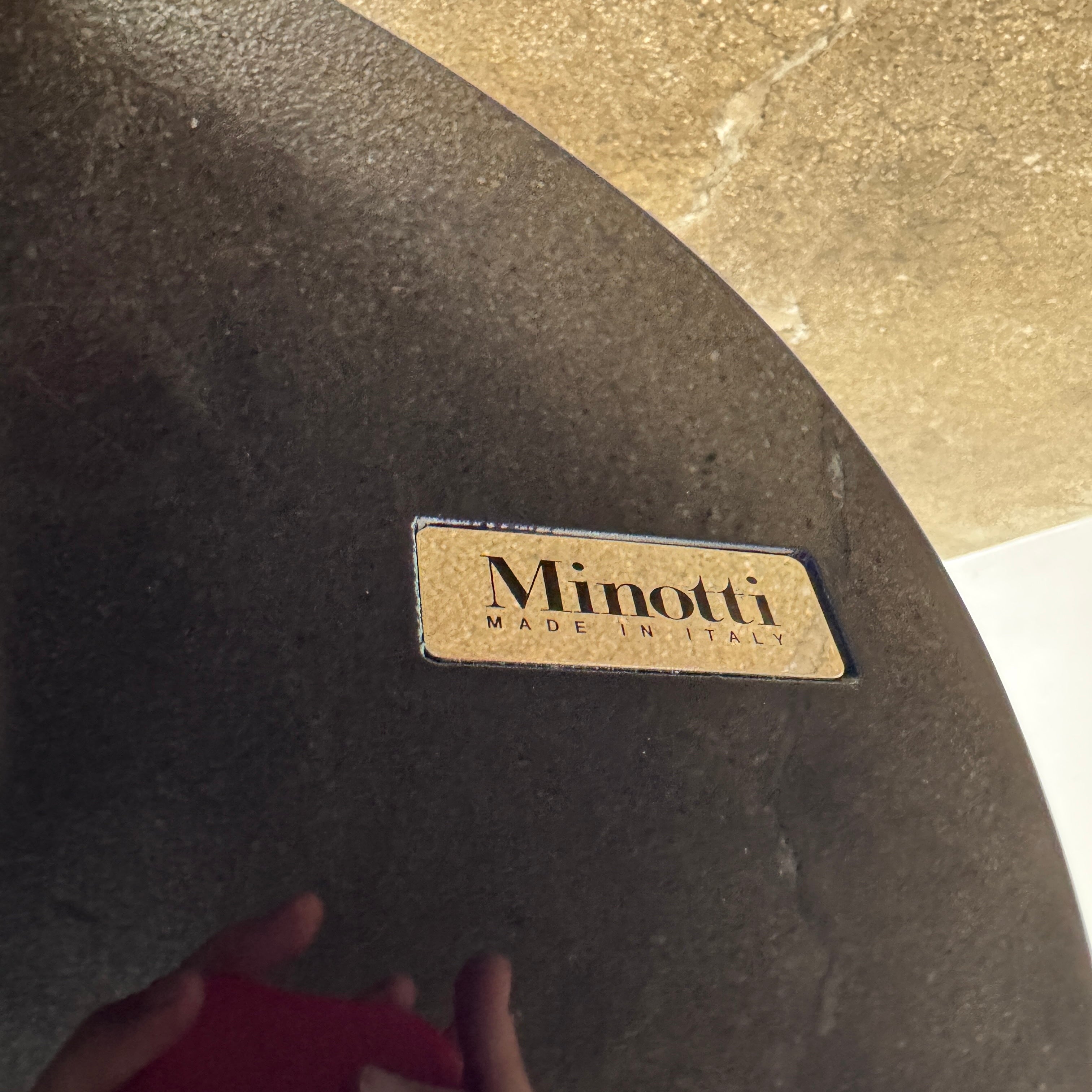 A sleek Minotti Raymond Coffee Table with a metal base, exhibiting clean shapes and proportions.