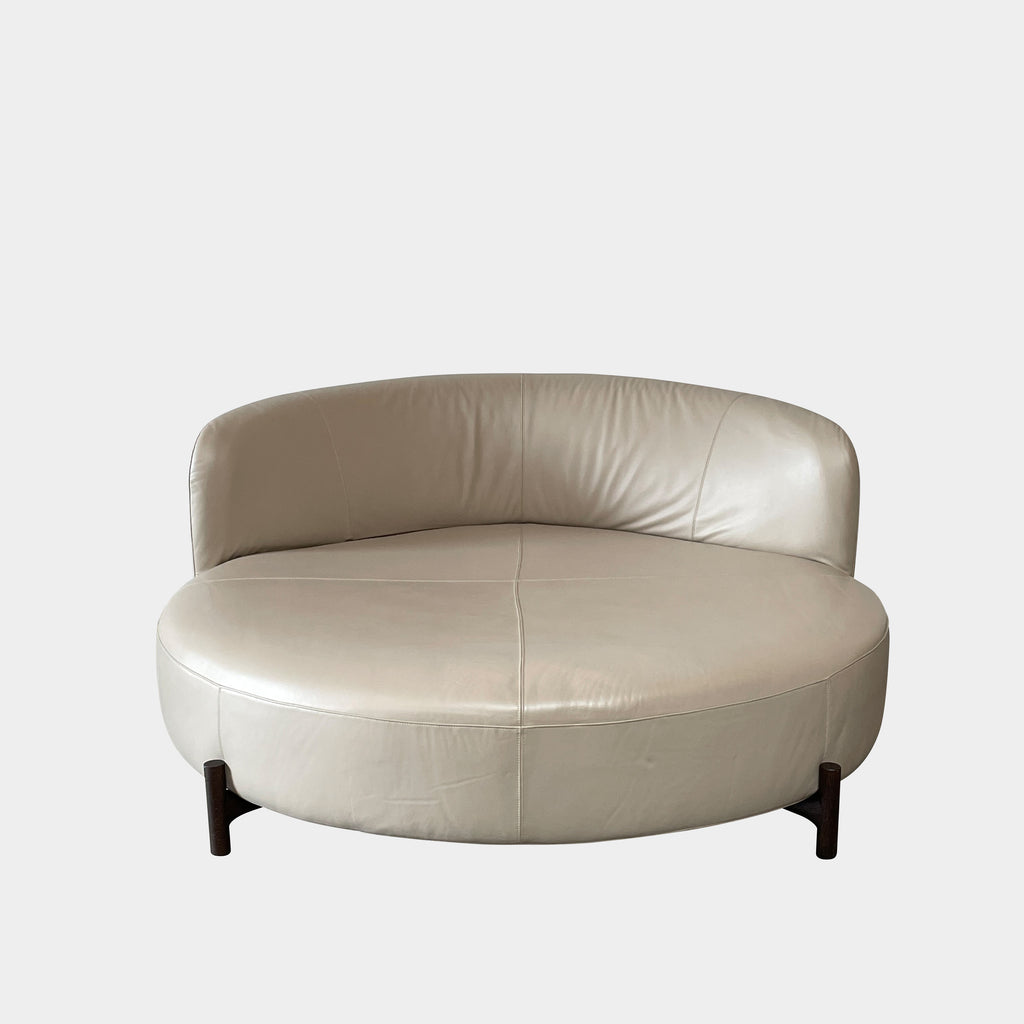A beige oval-shaped Natuzzi Italia Amalia Round Sofa isolated on a white background.