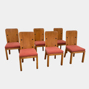 A set of six Waldo's Designs dining chairs in the style of Axel Enar Lovo, featuring rectangular backs and coral upholstery, are neatly arranged in two rows against a plain white background.