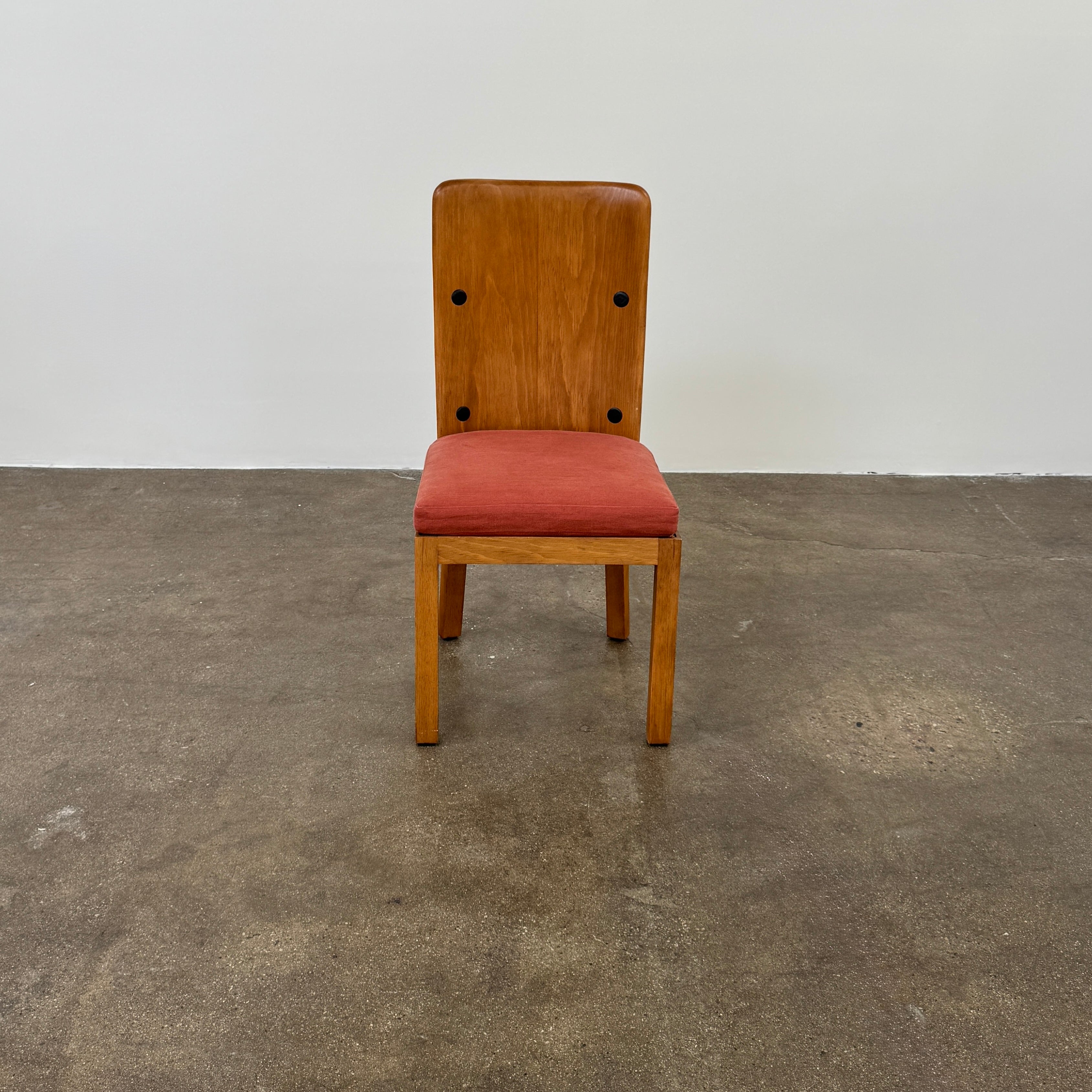 A set of six Waldo's Designs dining chairs in the style of Axel Enar Lovo, featuring rectangular backs and coral upholstery, are neatly arranged in two rows against a plain white background.