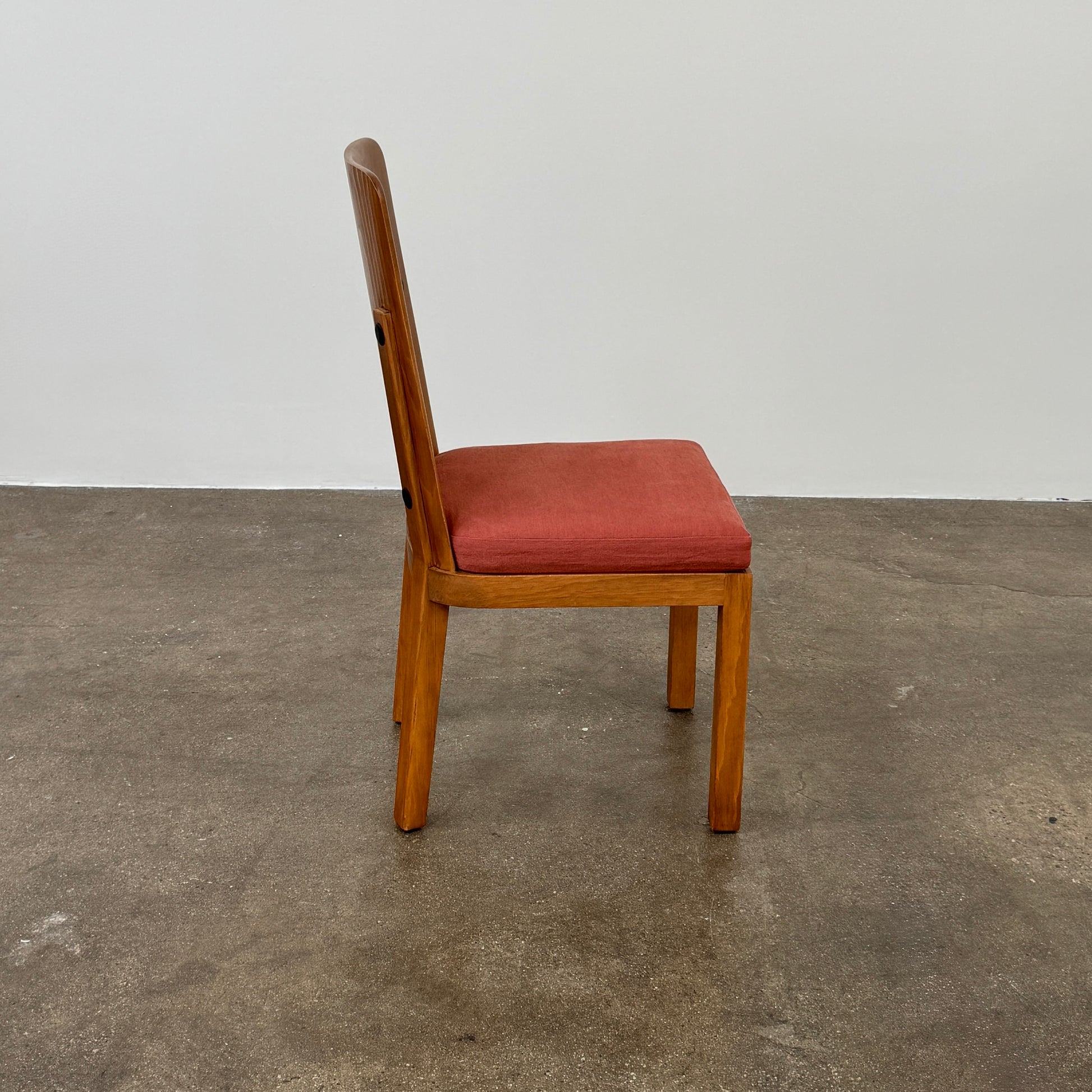 A set of six Waldo's Designs dining chairs in the style of Axel Enar Lovo, featuring rectangular backs and coral upholstery, are neatly arranged in two rows against a plain white background.