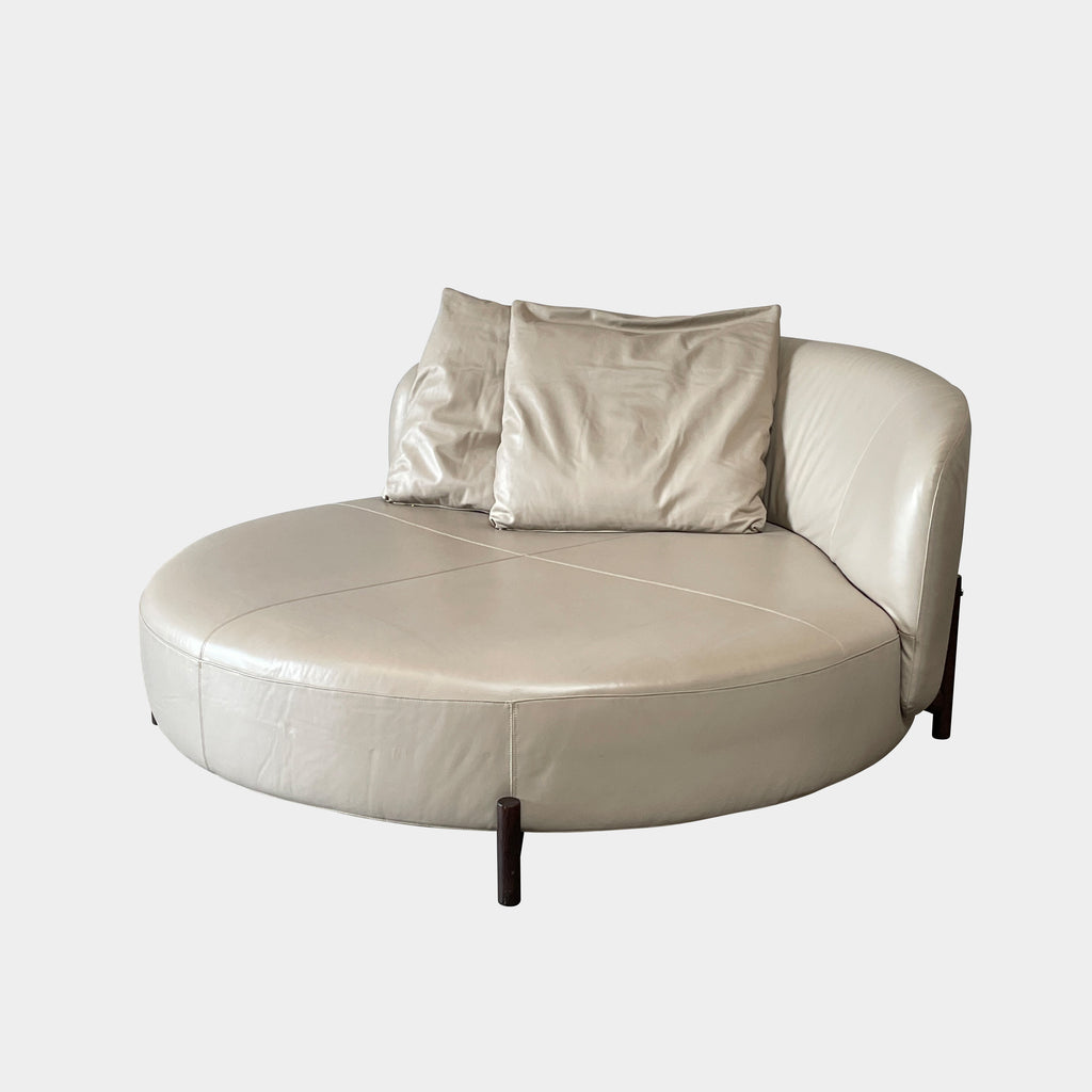 A beige oval-shaped Natuzzi Italia Amalia Round Sofa isolated on a white background.