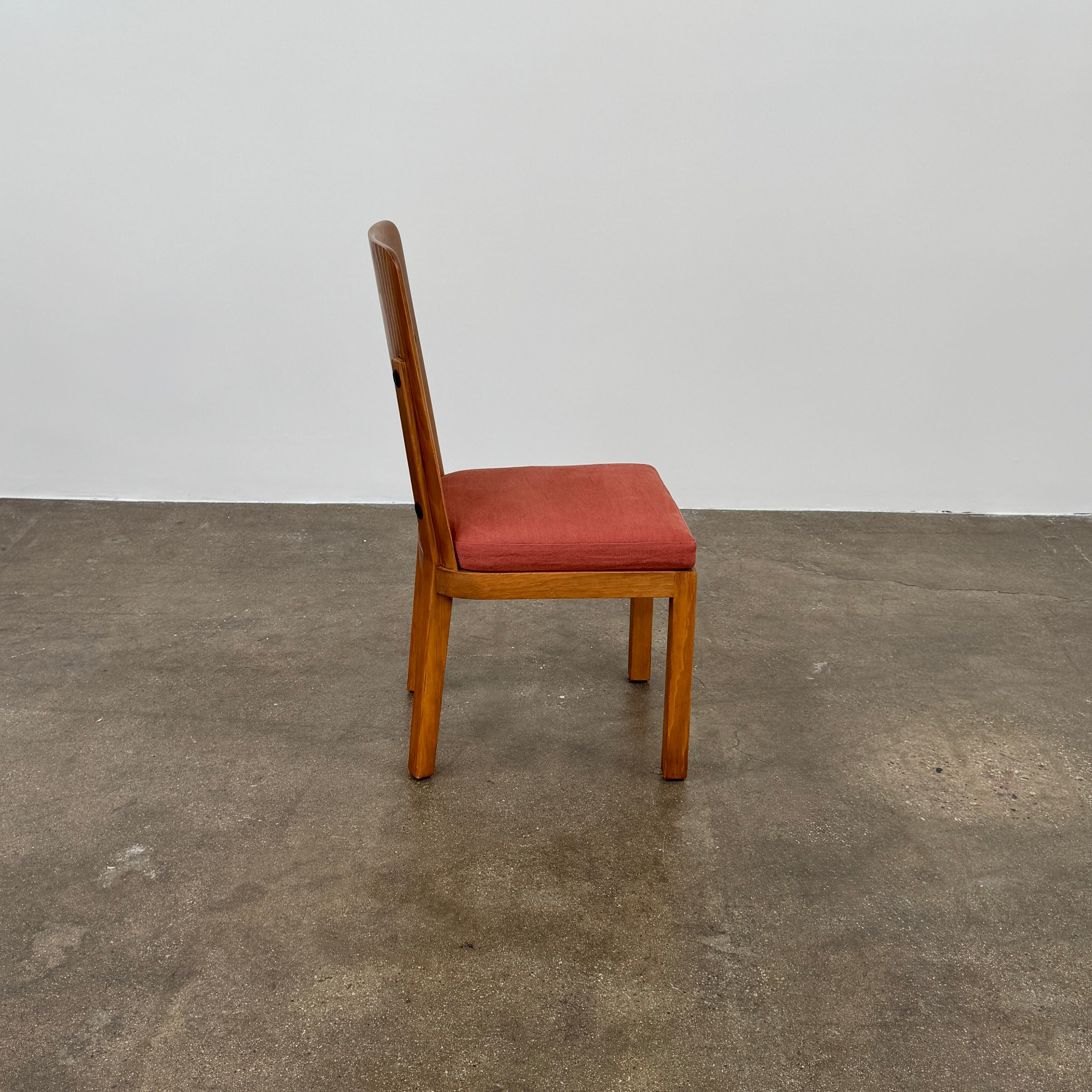 A set of six Waldo's Designs dining chairs in the style of Axel Enar Lovo, featuring rectangular backs and coral upholstery, are neatly arranged in two rows against a plain white background.
