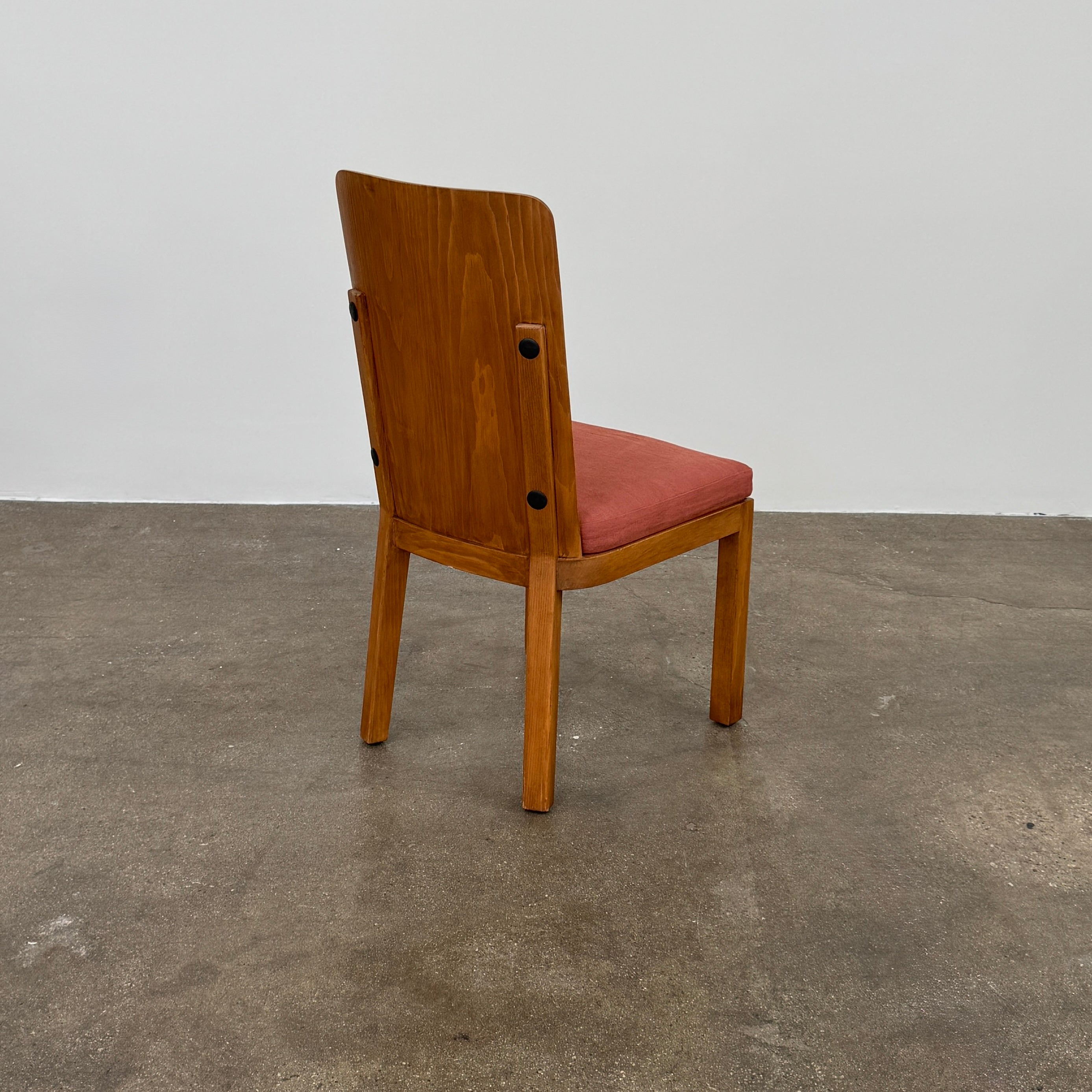 A set of six Waldo's Designs dining chairs in the style of Axel Enar Lovo, featuring rectangular backs and coral upholstery, are neatly arranged in two rows against a plain white background.