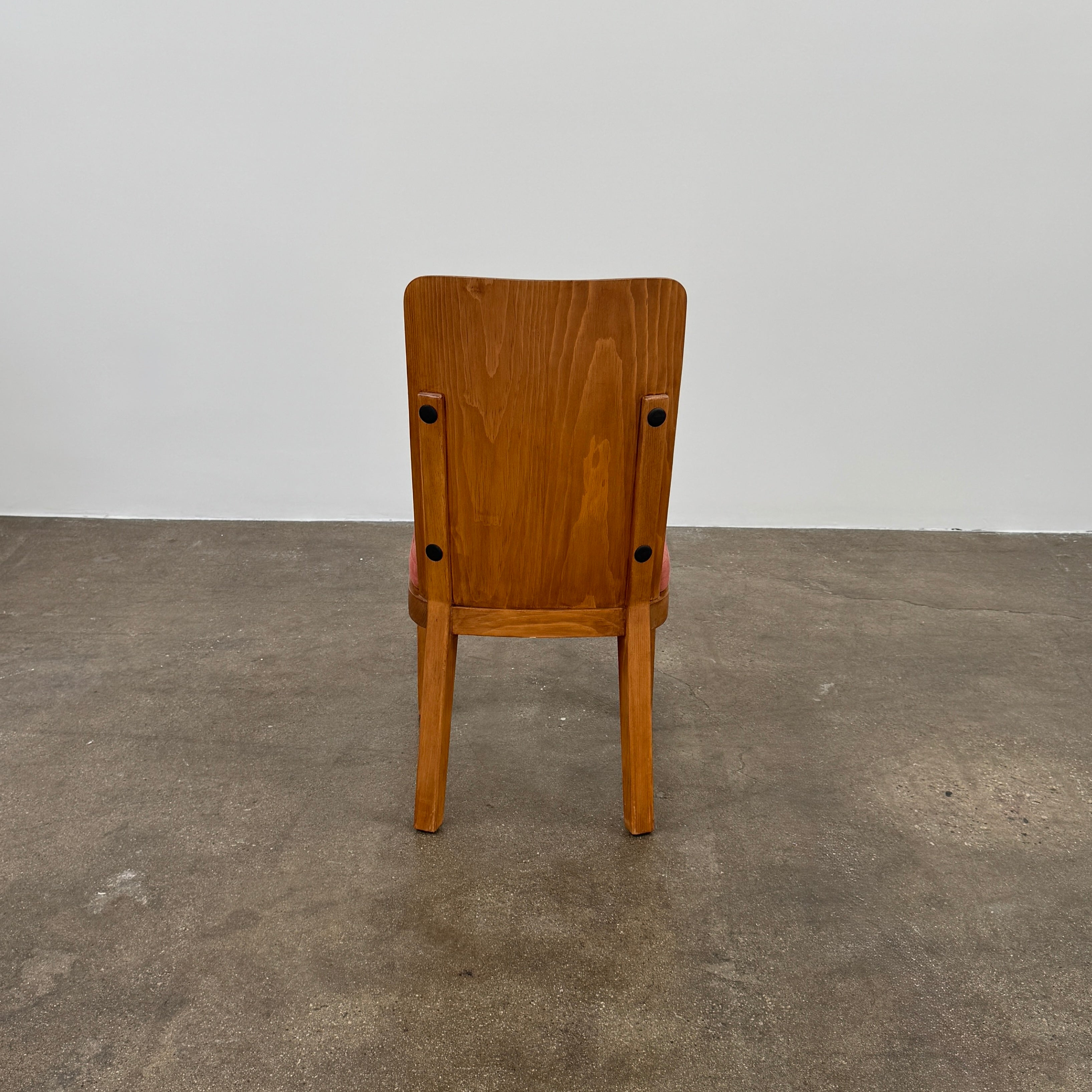 A set of six Waldo's Designs dining chairs in the style of Axel Enar Lovo, featuring rectangular backs and coral upholstery, are neatly arranged in two rows against a plain white background.