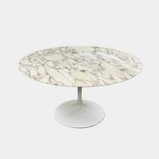 The Knoll Saarinen Table 54" Round Arabescato Marble features a white base and pedestal stand, inspired by the original Knoll design and shown isolated on a white background.