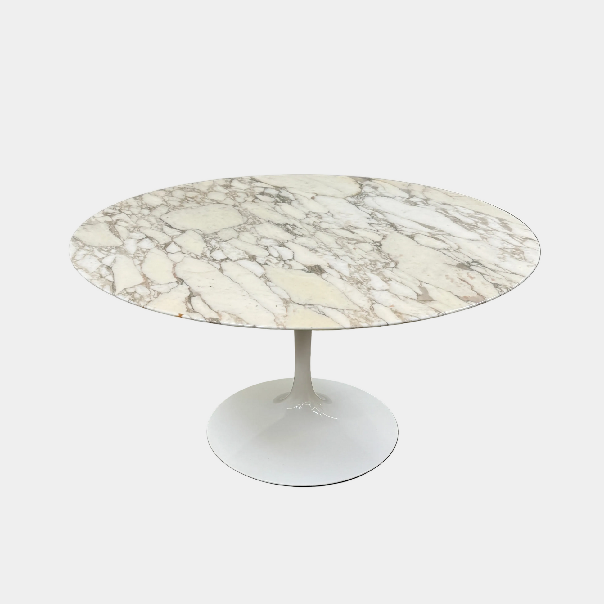 The Knoll Saarinen Table 54" Round Arabescato Marble features a white base and pedestal stand, inspired by the original Knoll design and shown isolated on a white background.