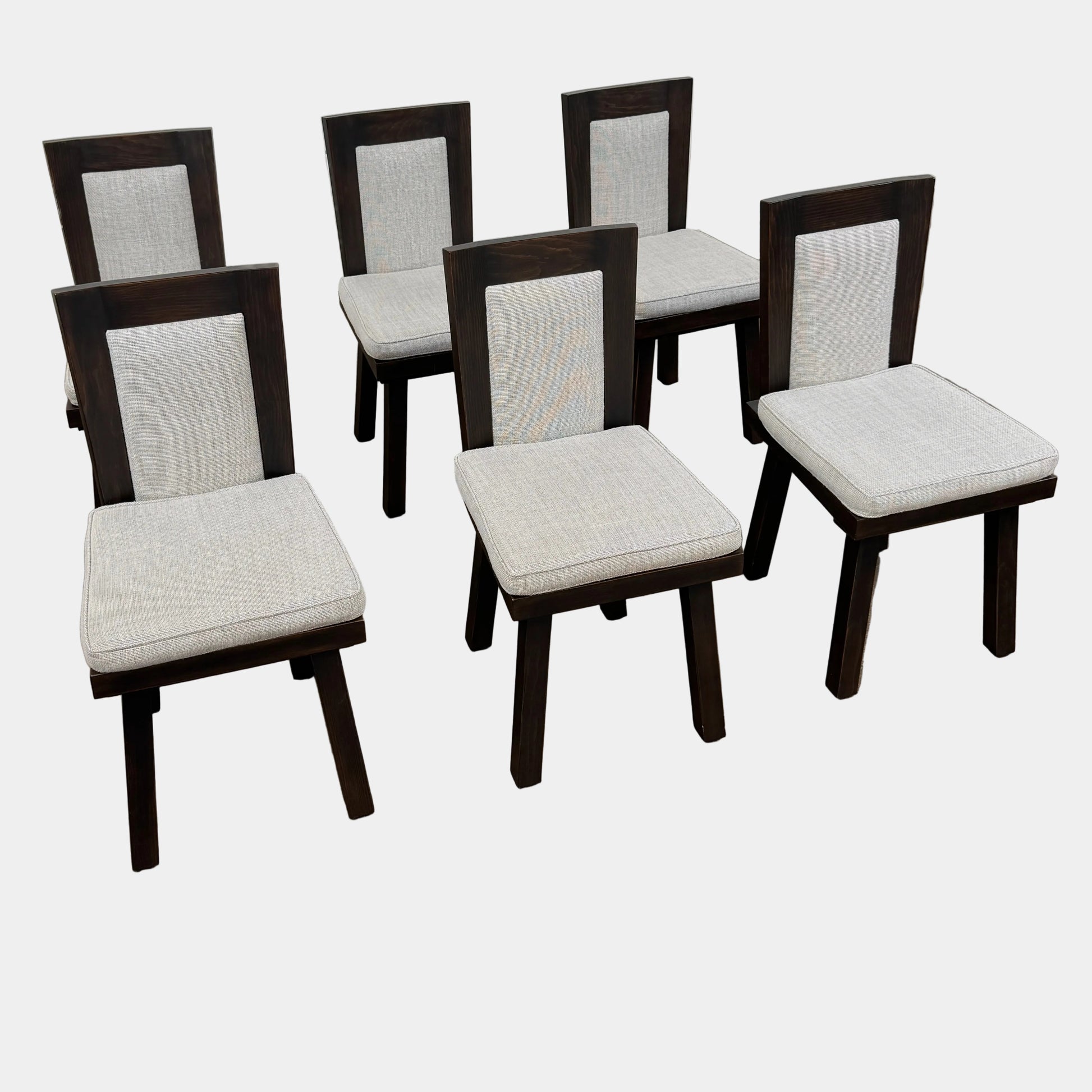 Six Waldo's Designs Custom Pine Dining Chairs (Set of 6) with light upholstered seats and backs are arranged in two rows on a bare concrete floor against a plain white wall.
