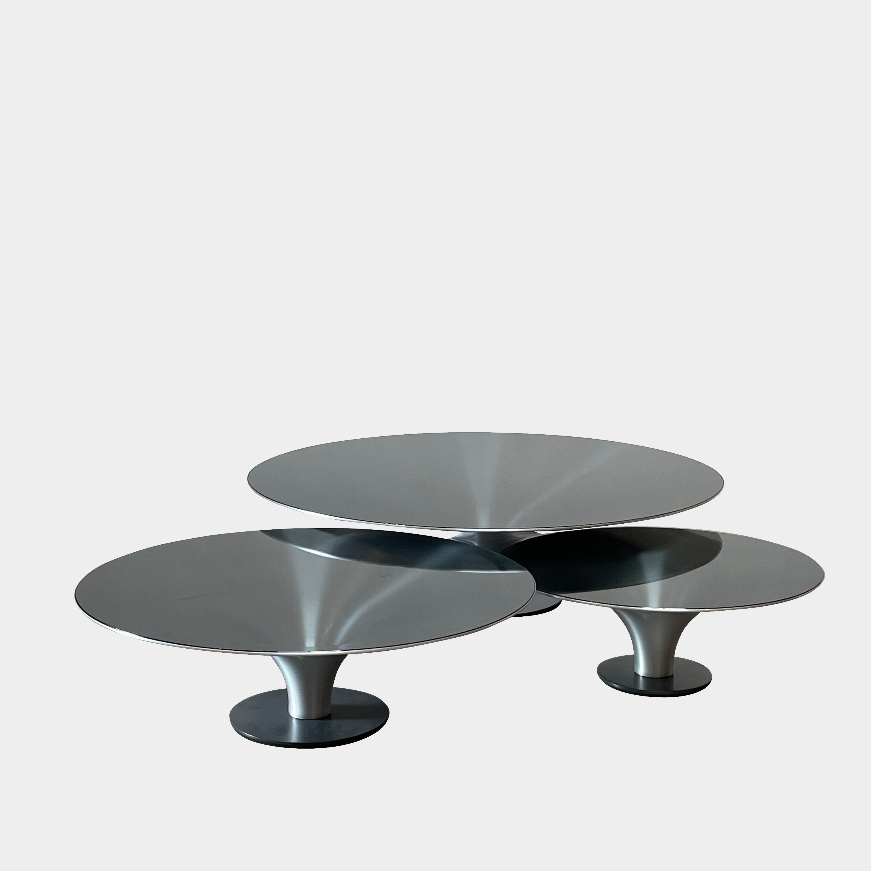Three Roche Bobois Ovni Cocktail Tables of different sizes with reflective surfaces, isolated on a white background.