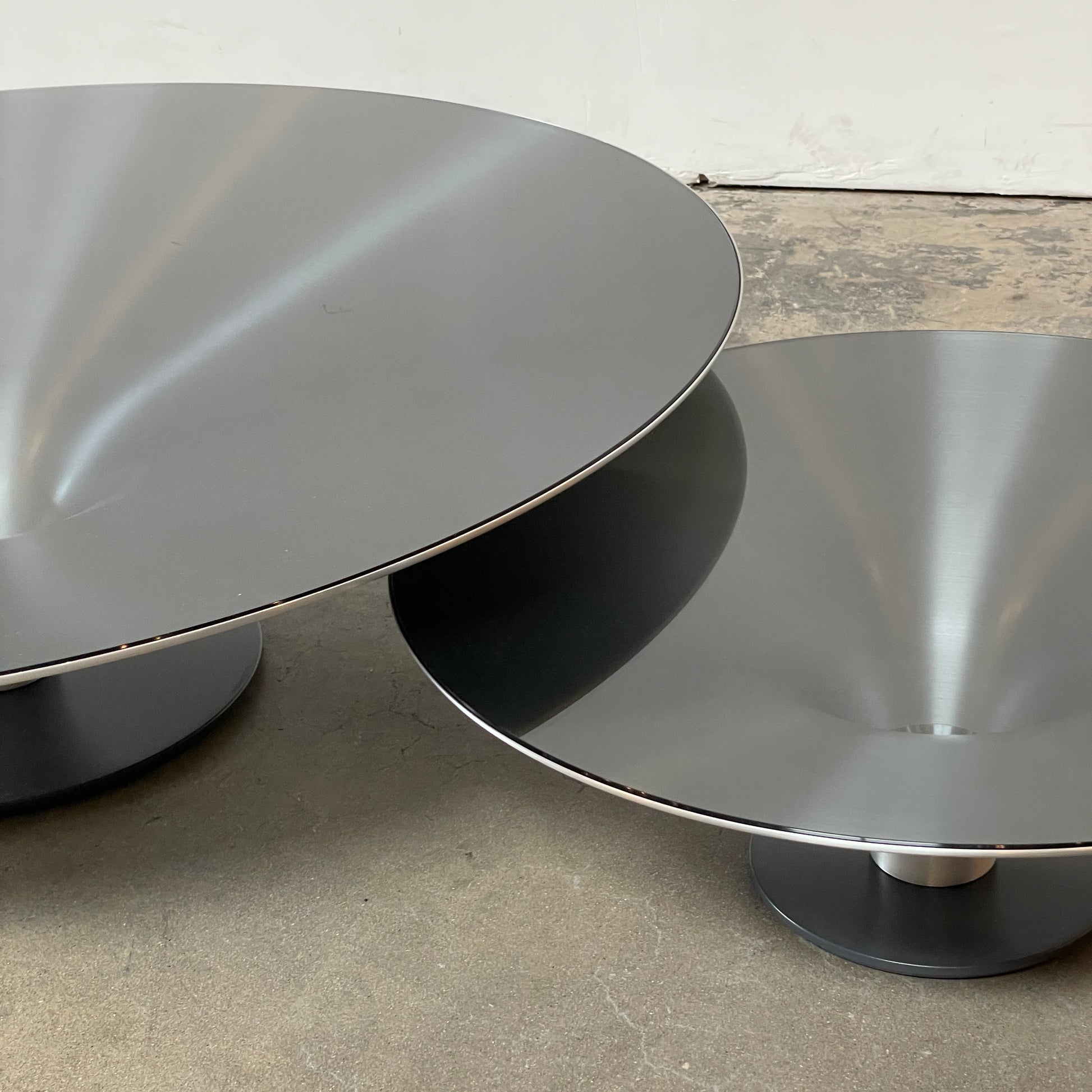 Three Roche Bobois Ovni Cocktail Tables of different sizes with reflective surfaces, isolated on a white background.
