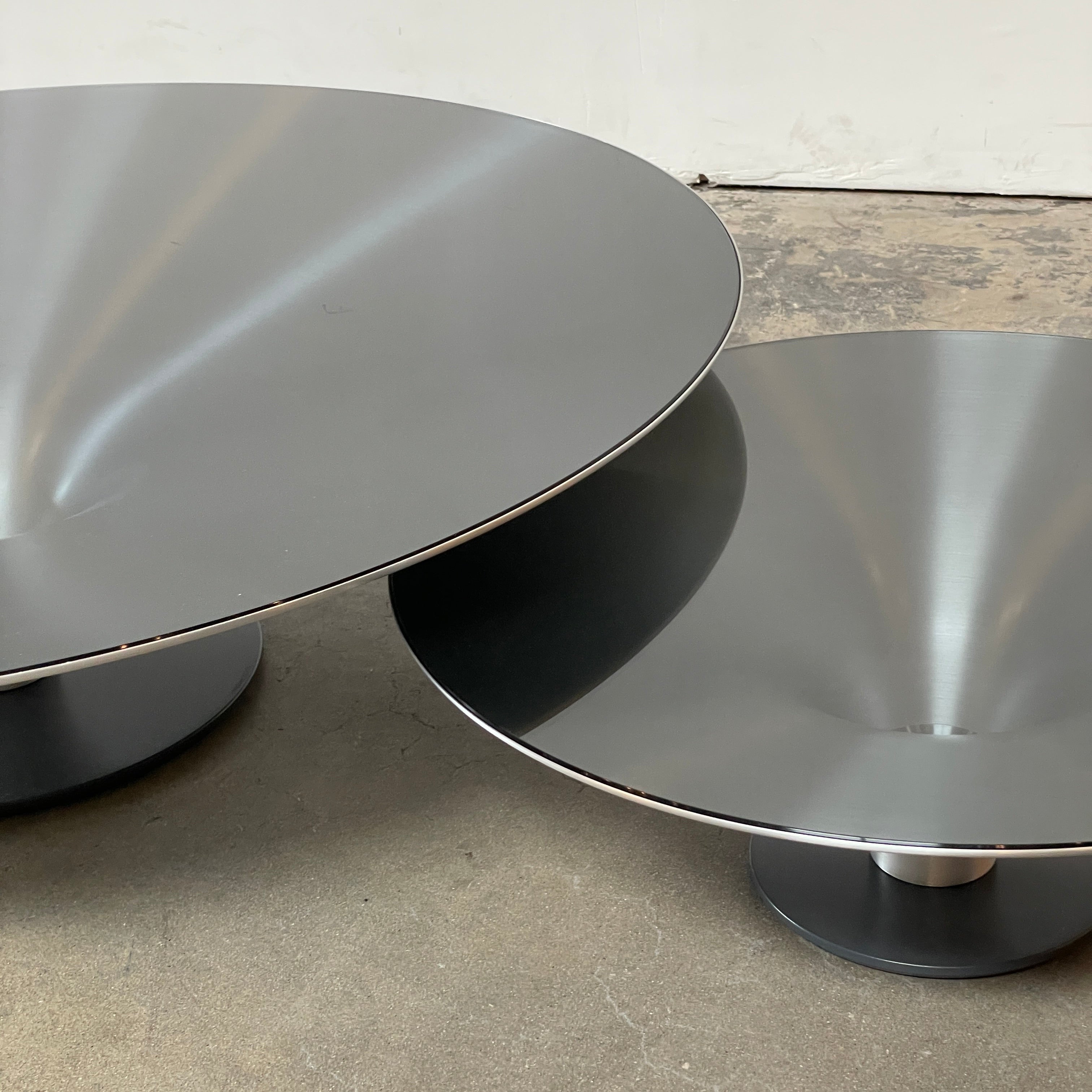 Three Roche Bobois Ovni Cocktail Tables of different sizes with reflective surfaces, isolated on a white background.