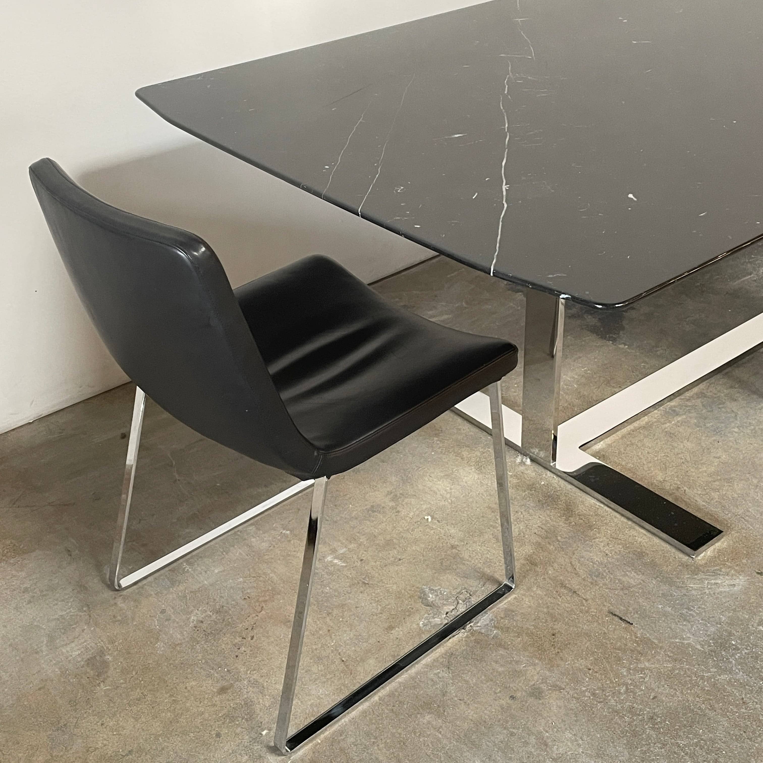 Five black B&B Italia Metropolitan dining chairs designed by Jeffrey Bernett, arranged in a row on a white background.