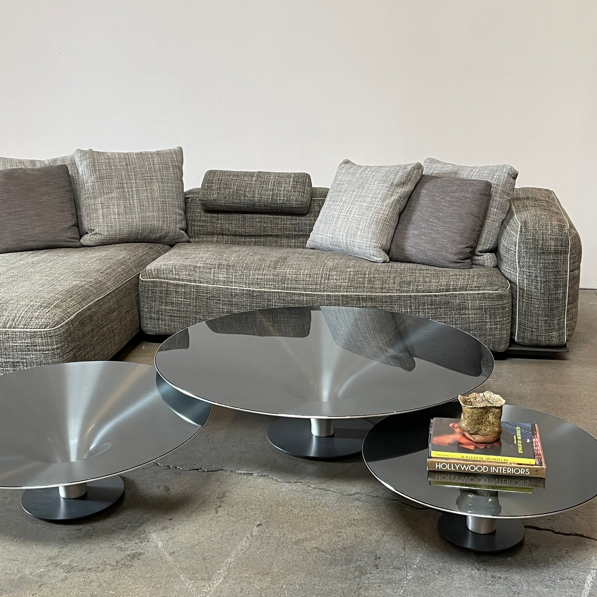 Three Roche Bobois Ovni Cocktail Tables of different sizes with reflective surfaces, isolated on a white background.