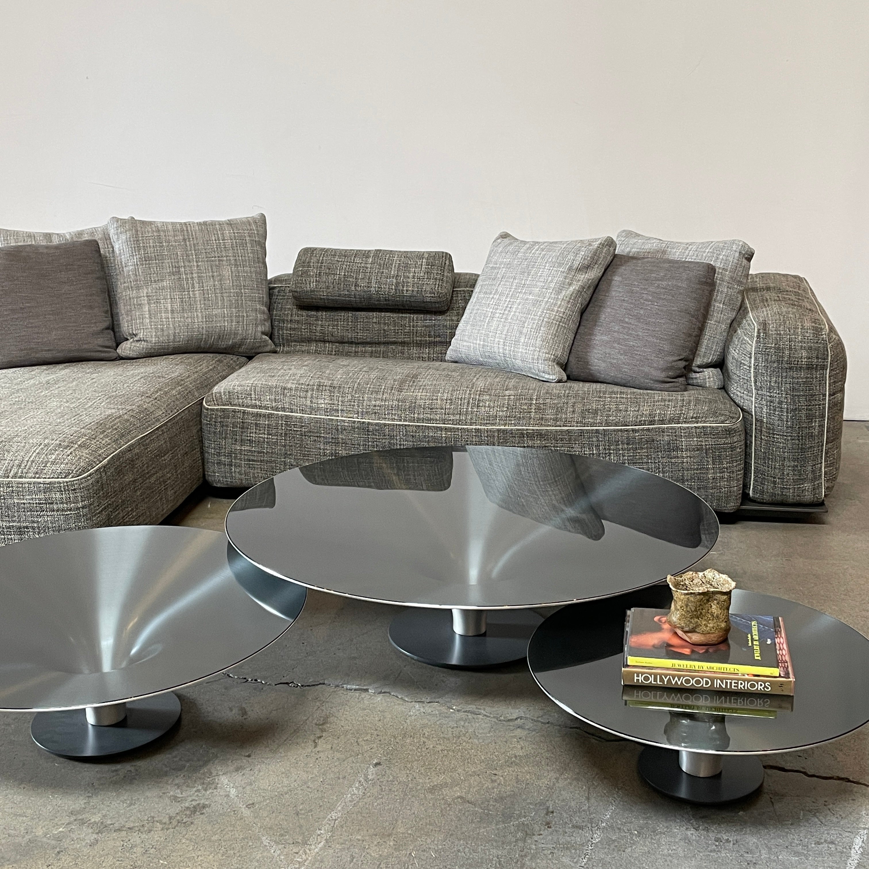 Three Roche Bobois Ovni Cocktail Tables of different sizes with reflective surfaces, isolated on a white background.