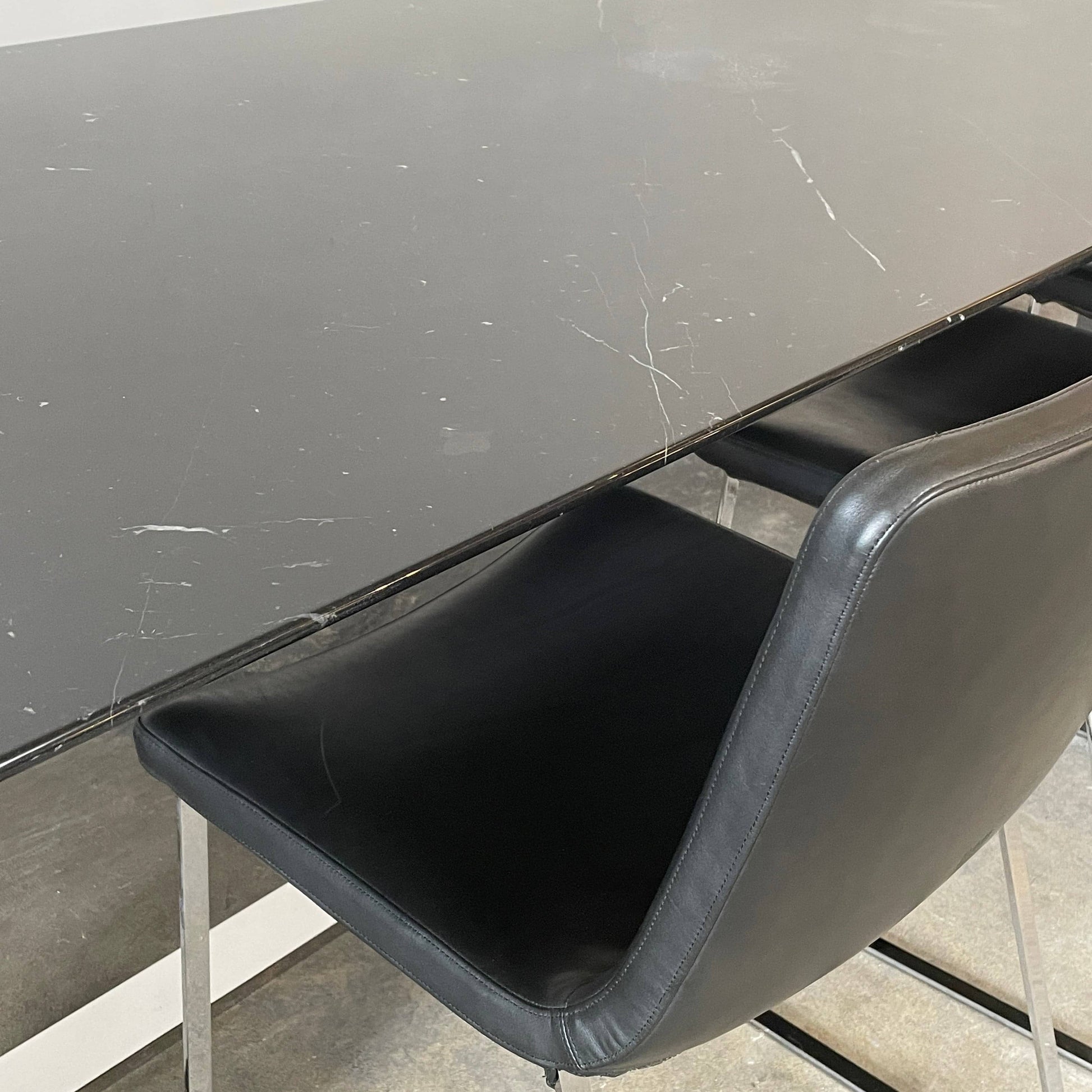 Five black B&B Italia Metropolitan dining chairs designed by Jeffrey Bernett, arranged in a row on a white background.