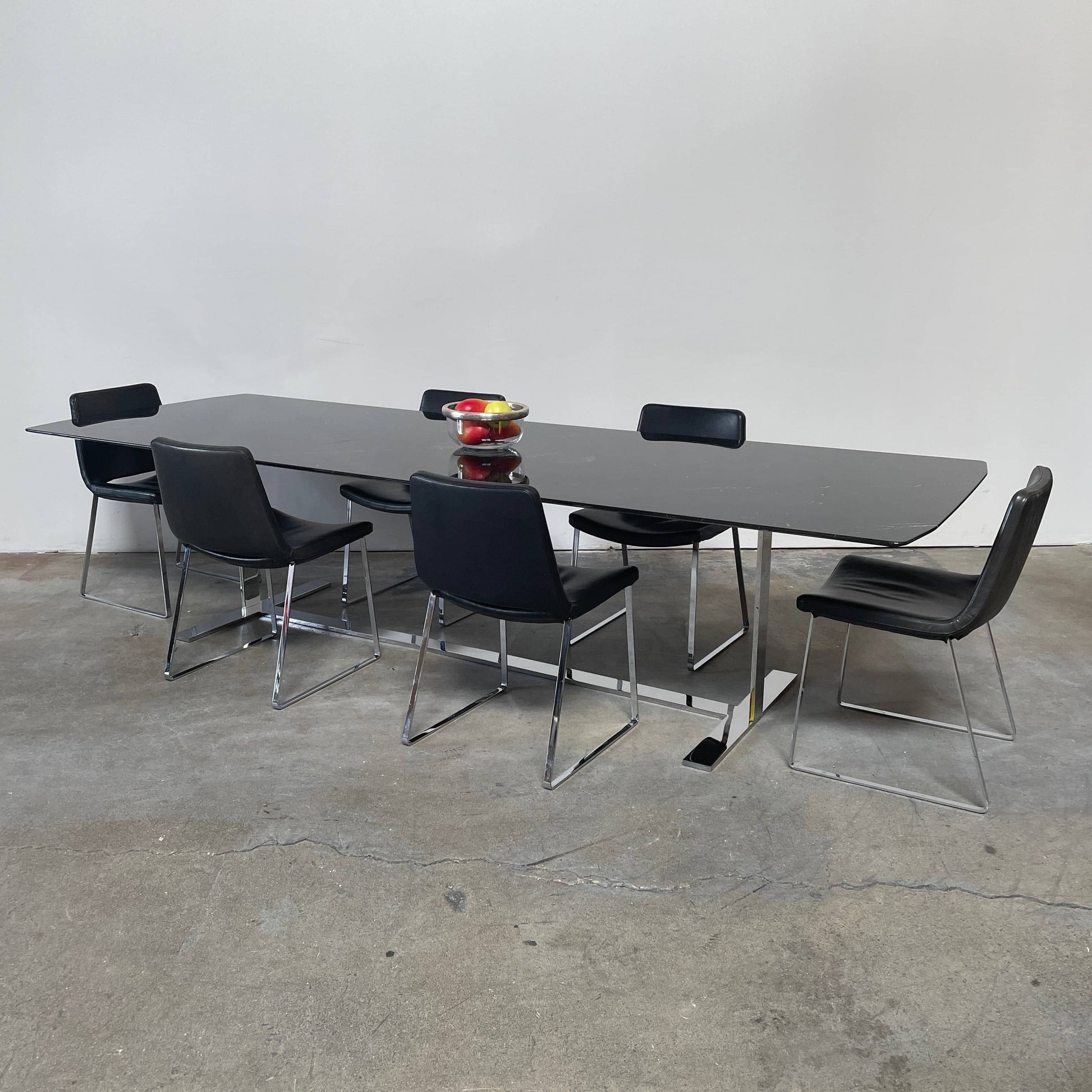 Five black B&B Italia Metropolitan dining chairs designed by Jeffrey Bernett, arranged in a row on a white background.