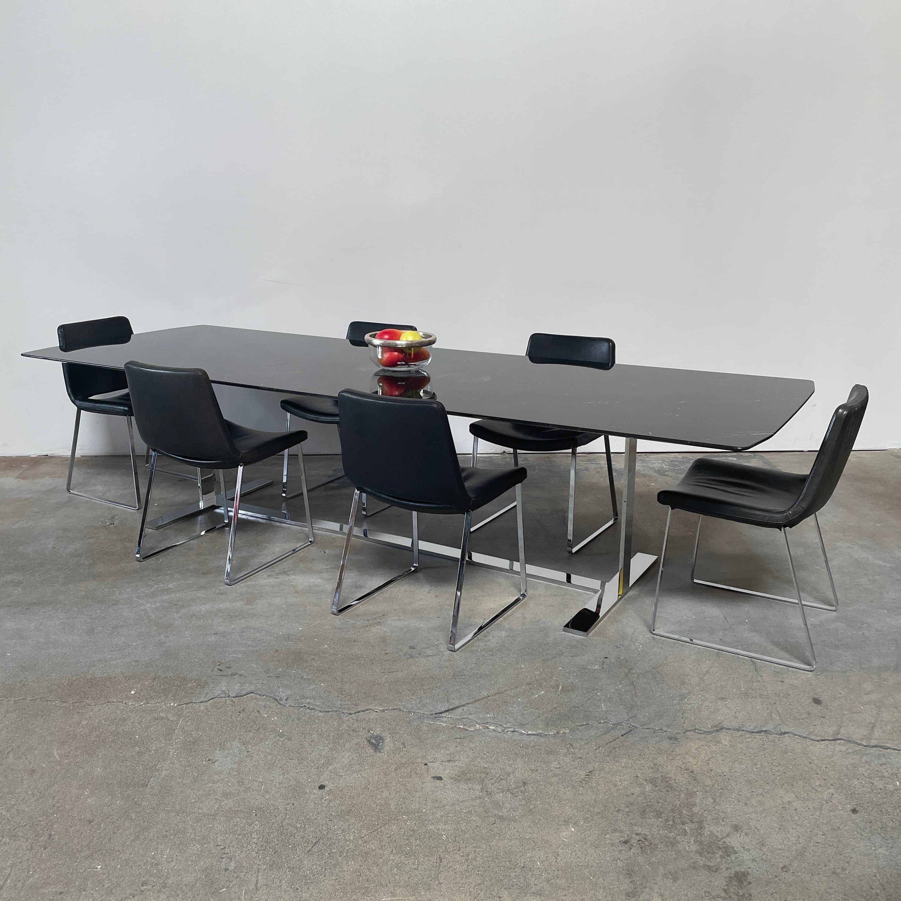 Five black B&B Italia Metropolitan dining chairs designed by Jeffrey Bernett, arranged in a row on a white background.