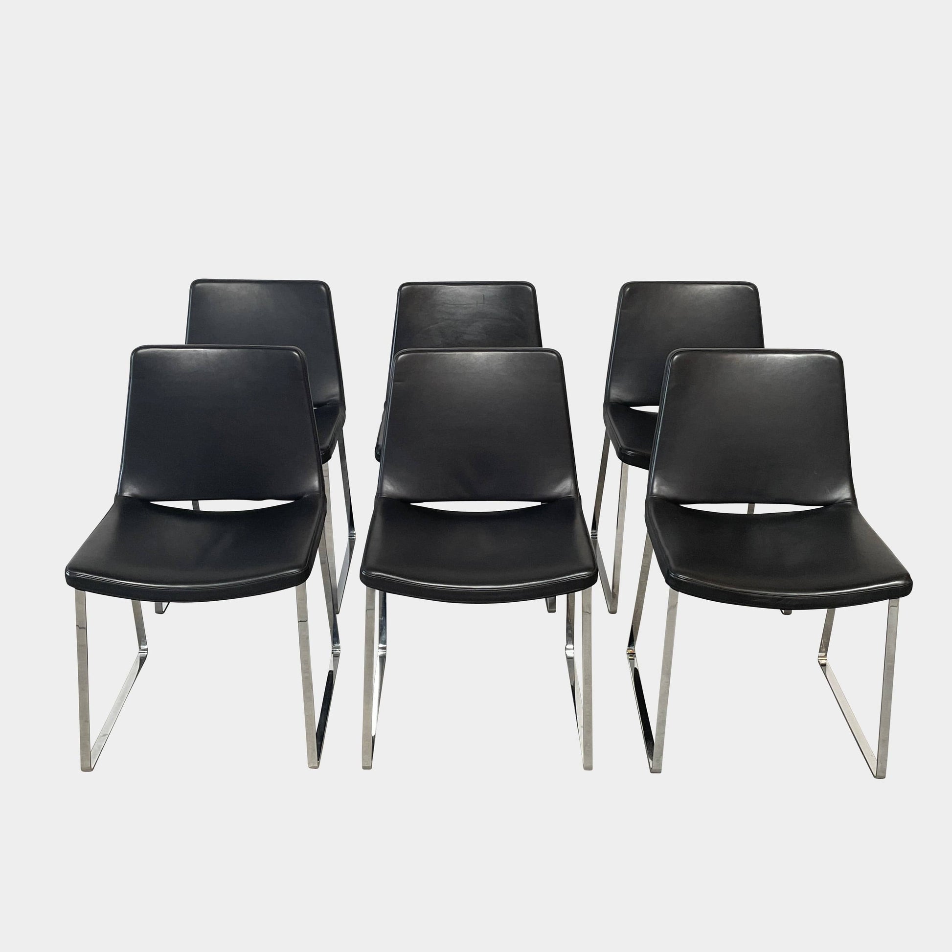 Five black B&B Italia Metropolitan dining chairs designed by Jeffrey Bernett, arranged in a row on a white background.