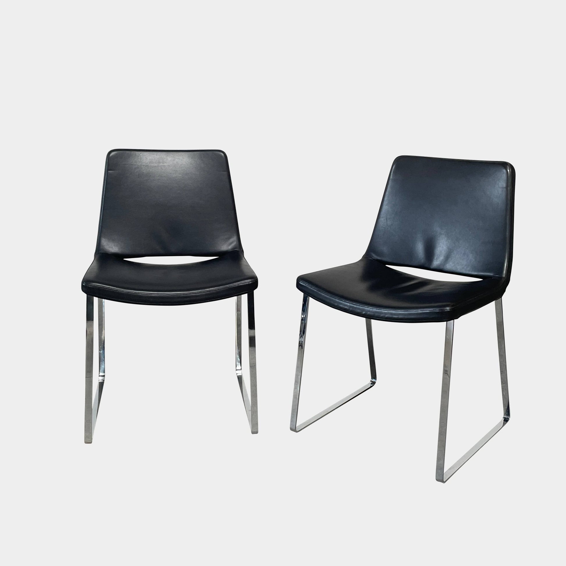 Five black B&B Italia Metropolitan dining chairs designed by Jeffrey Bernett, arranged in a row on a white background.