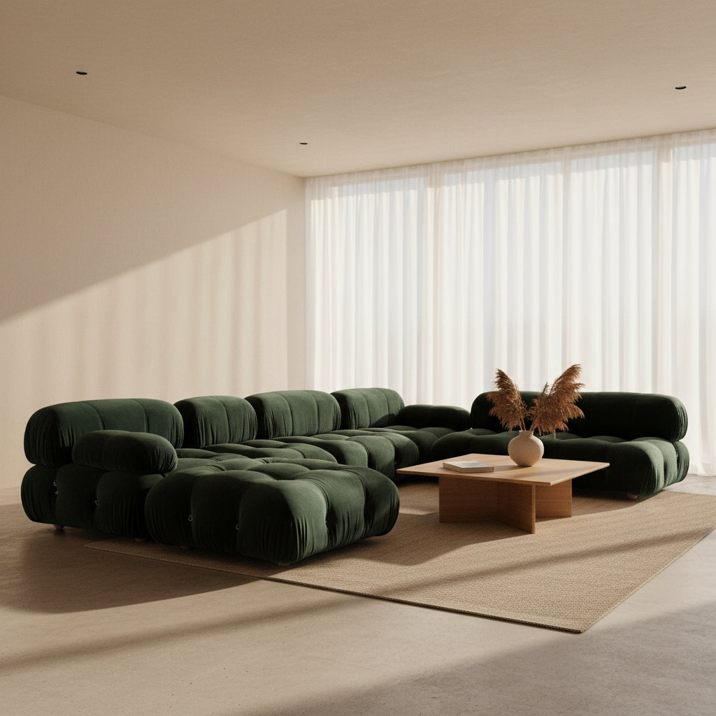 The B&B Italia Camaleonda 7 Piece Modular Sofa by B&B Italia features tufted dark green velvet, multiple connected seats, and one armrest, inspired by the original Camaleonda design, set against a plain white background.