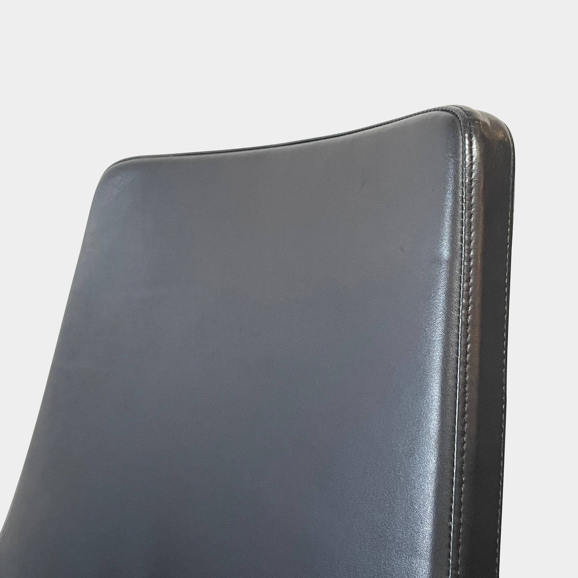 Five black B&B Italia Metropolitan dining chairs designed by Jeffrey Bernett, arranged in a row on a white background.