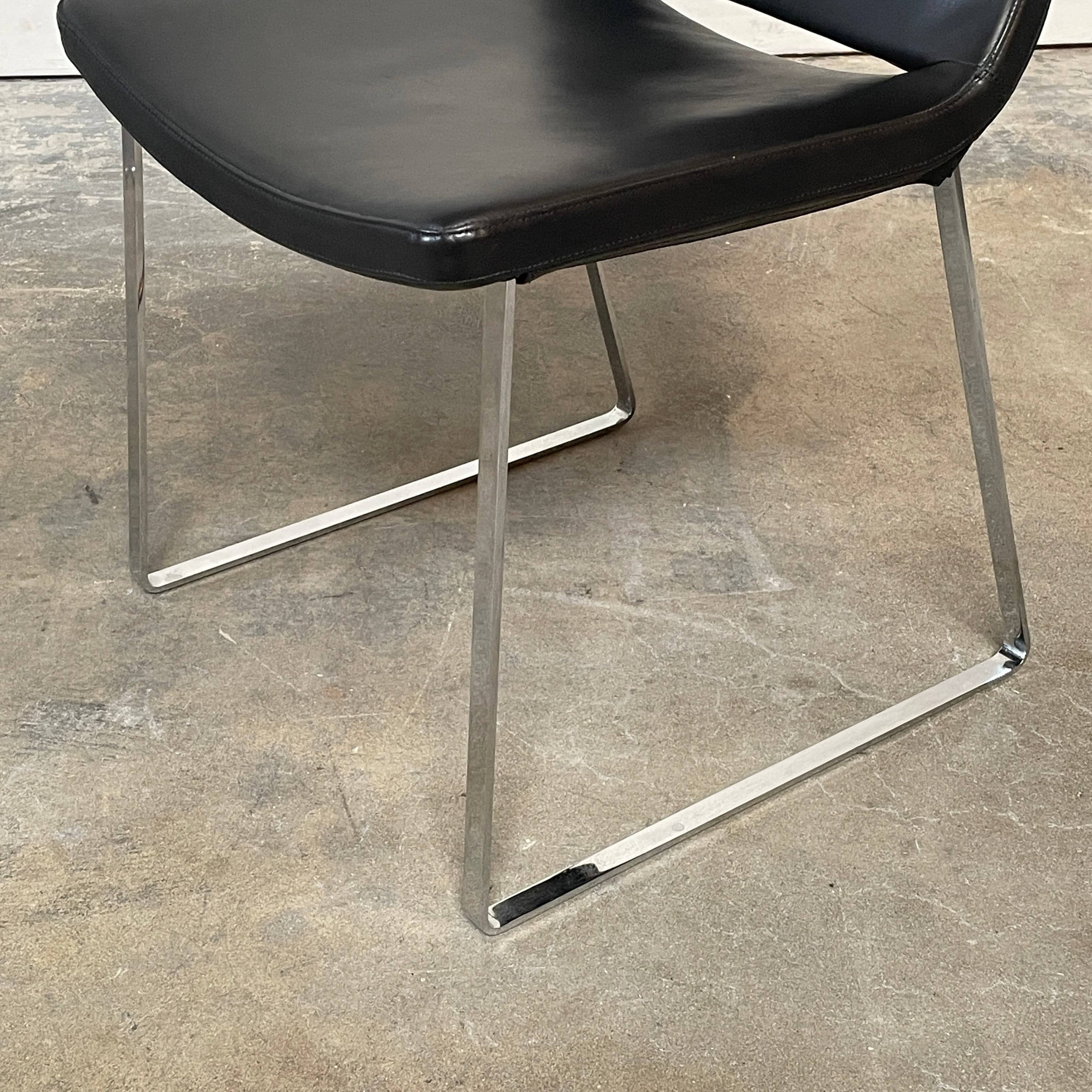 Five black B&B Italia Metropolitan dining chairs designed by Jeffrey Bernett, arranged in a row on a white background.