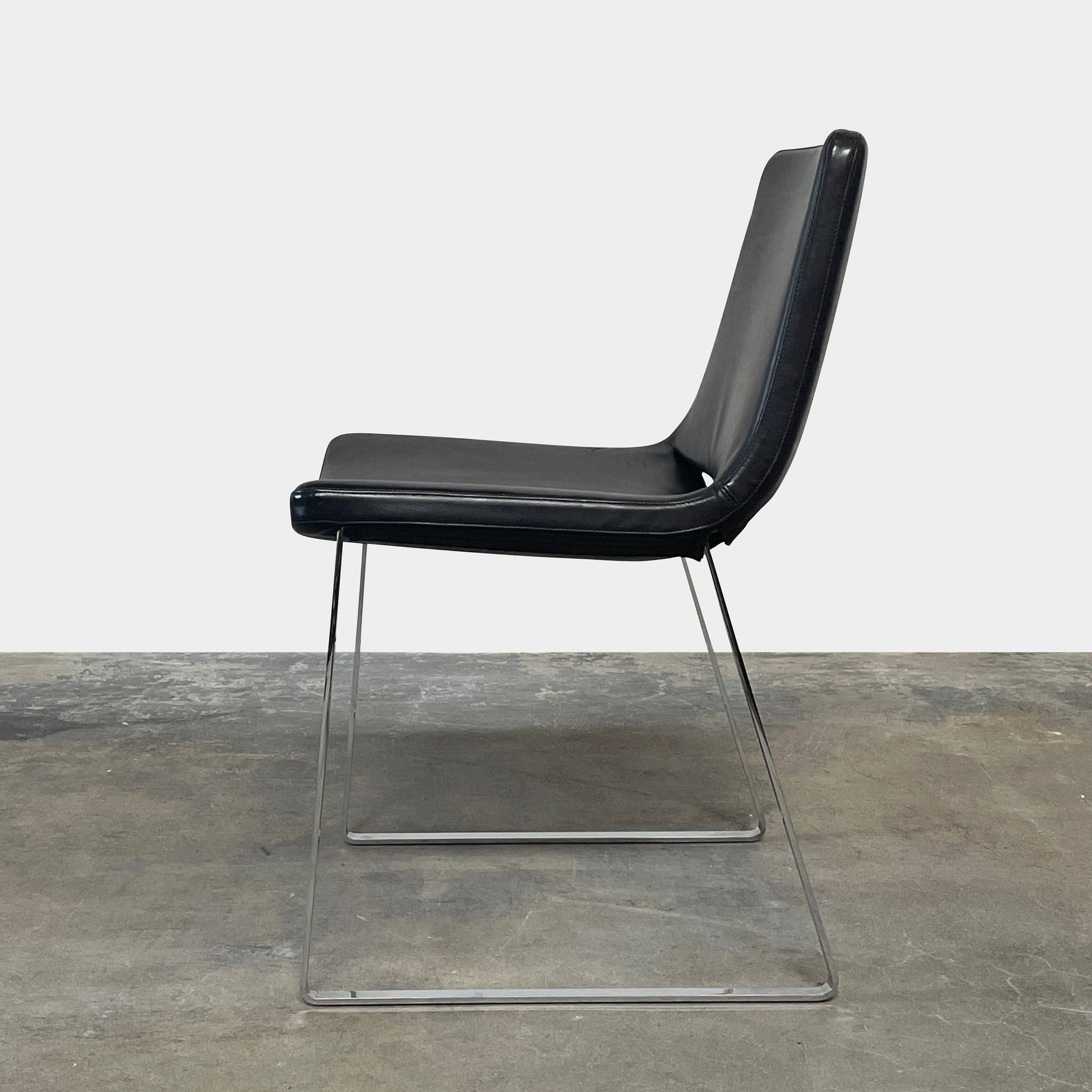 Five black B&B Italia Metropolitan dining chairs designed by Jeffrey Bernett, arranged in a row on a white background.