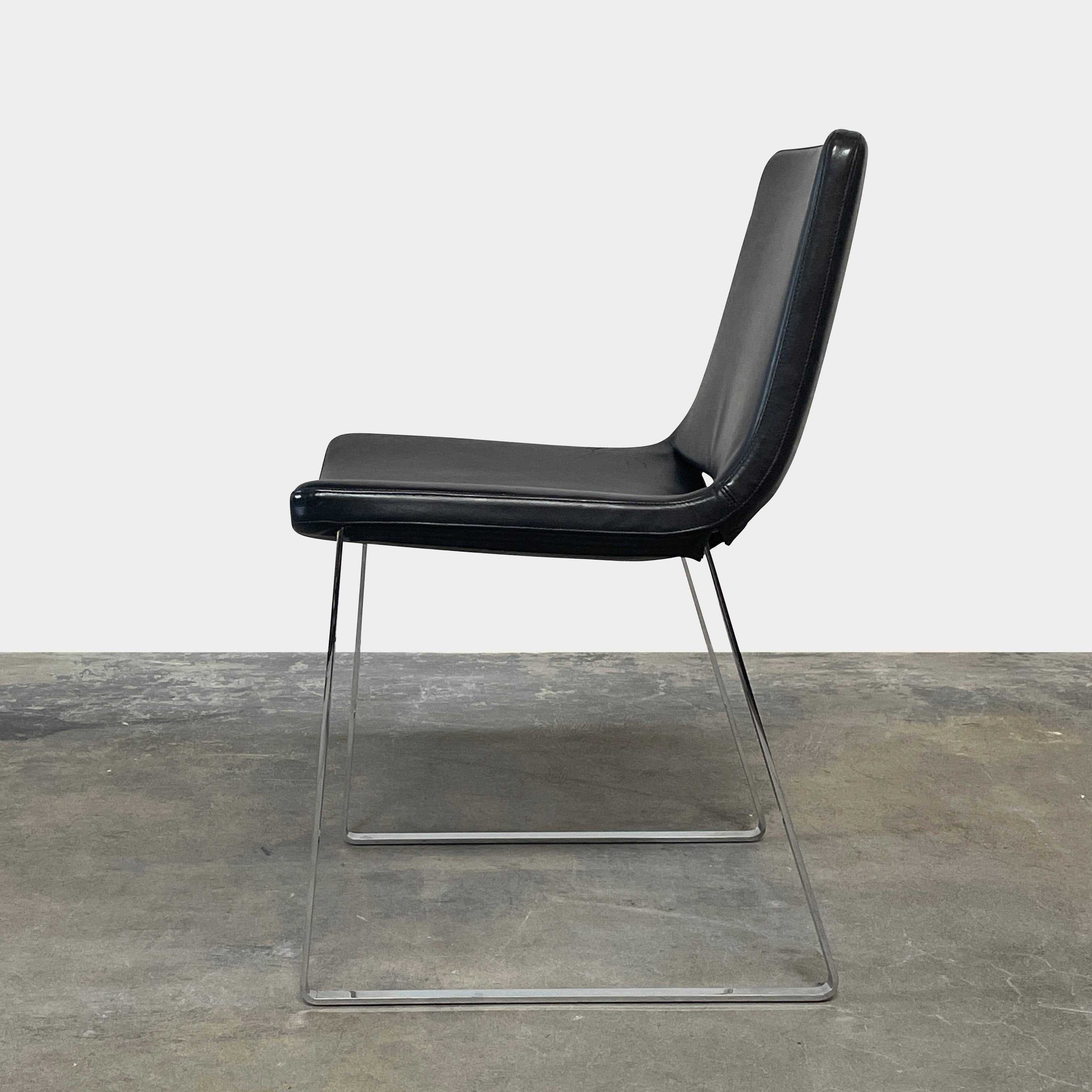 Five black B&B Italia Metropolitan dining chairs designed by Jeffrey Bernett, arranged in a row on a white background.