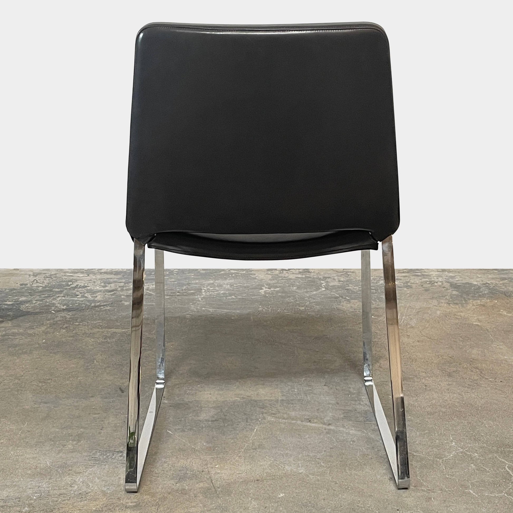 Five black B&B Italia Metropolitan dining chairs designed by Jeffrey Bernett, arranged in a row on a white background.