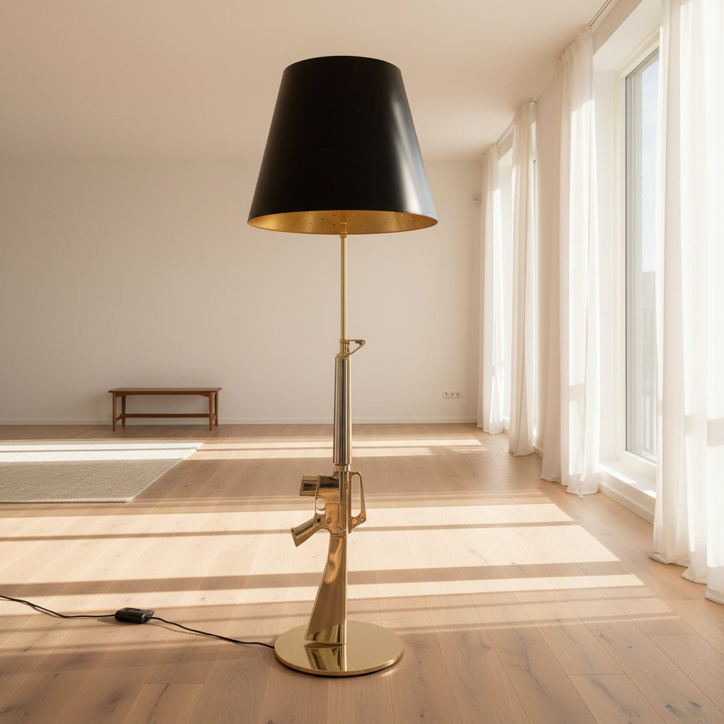 The Flos Guns Lounge Floor Lamp Gold by Flos features a shiny gold rifle-shaped base and a black lampshade, inspired by Philippe Starck, standing against a plain white background.