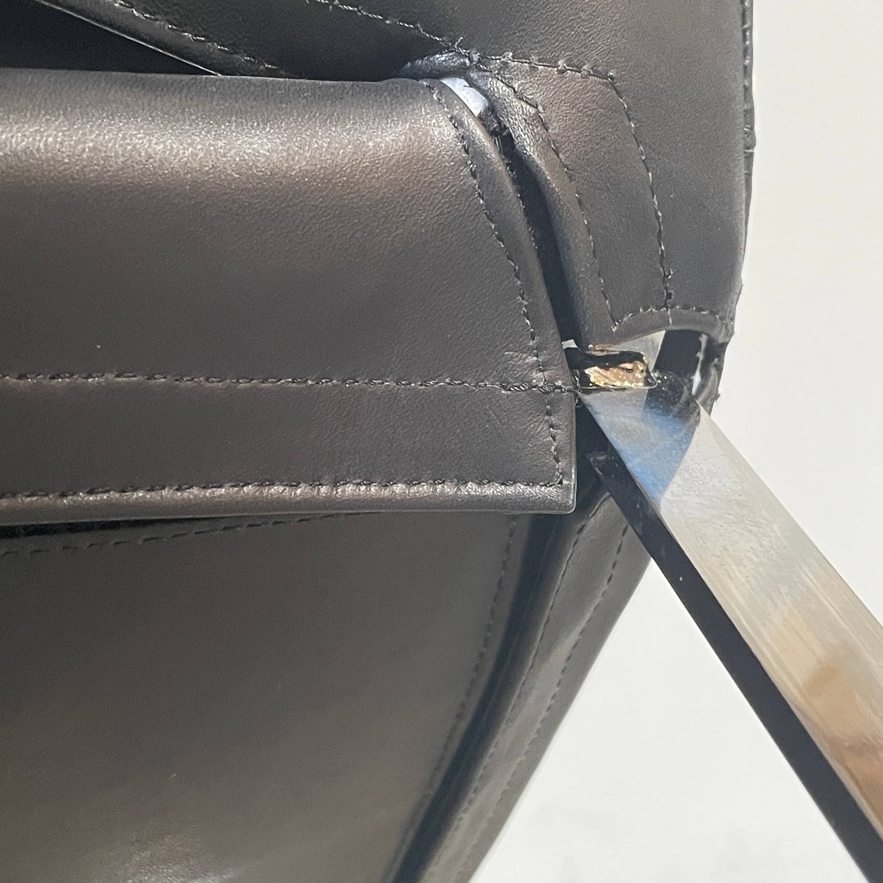 Five black B&B Italia Metropolitan dining chairs designed by Jeffrey Bernett, arranged in a row on a white background.