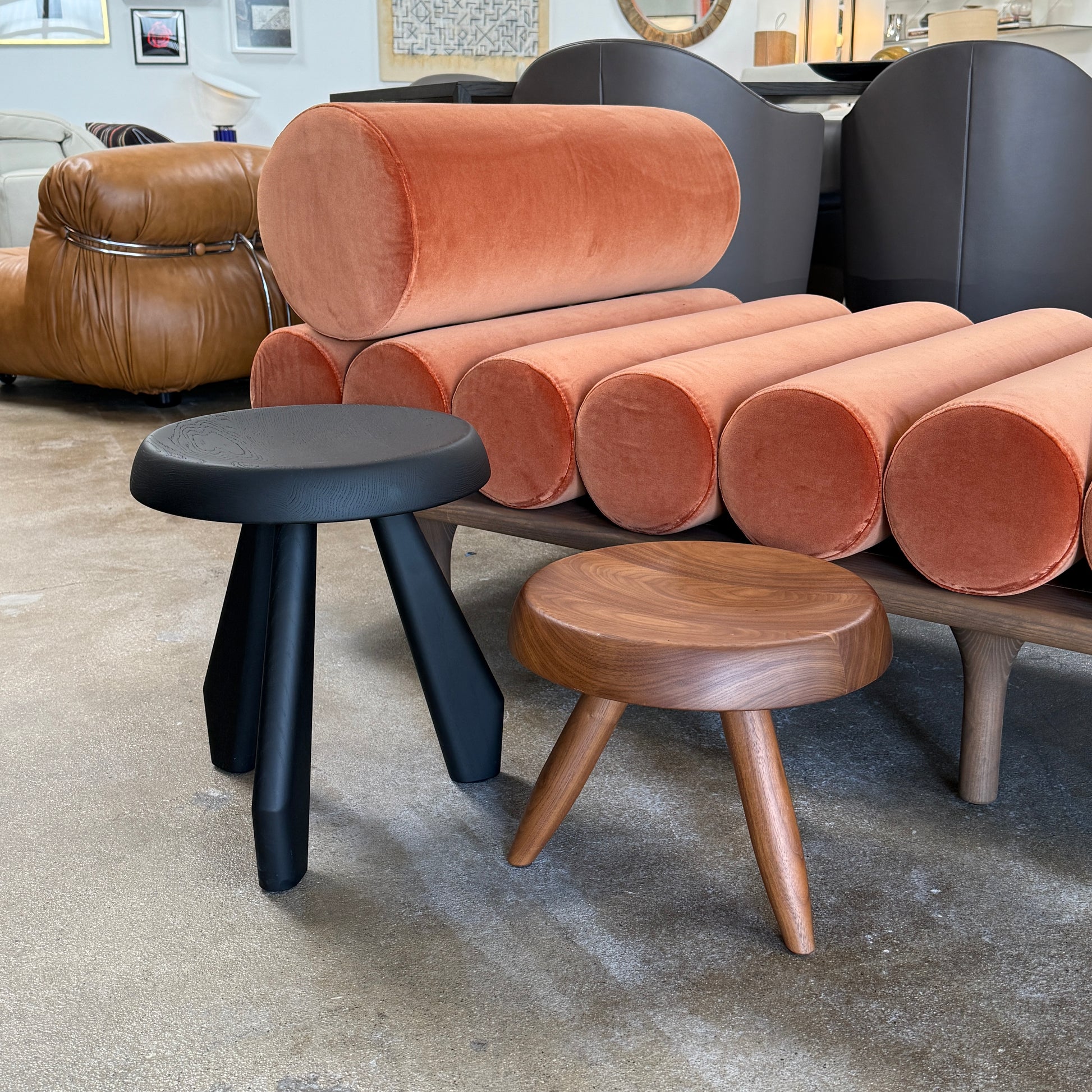 The Cassina “524 Tabouret Berger” stool by Cassina, crafted in walnut with three tapered legs and a round seat, is shown against a plain white background.