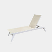 The Serge Ferrari Sun Lounger is a white, modern piece with an adjustable backrest, crafted from metal and mesh using durable Serge Ferrari fabric, shown on a plain white background.