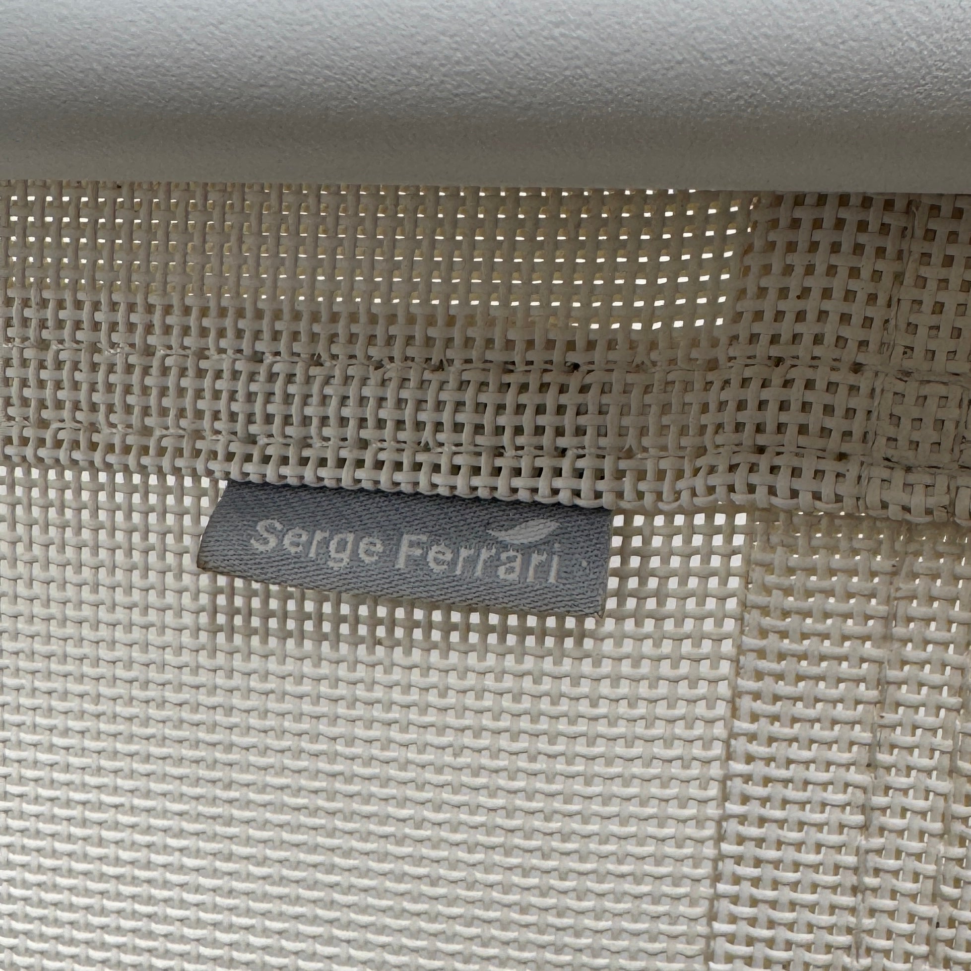 The Serge Ferrari Sun Lounger is a white, modern piece with an adjustable backrest, crafted from metal and mesh using durable Serge Ferrari fabric, shown on a plain white background.