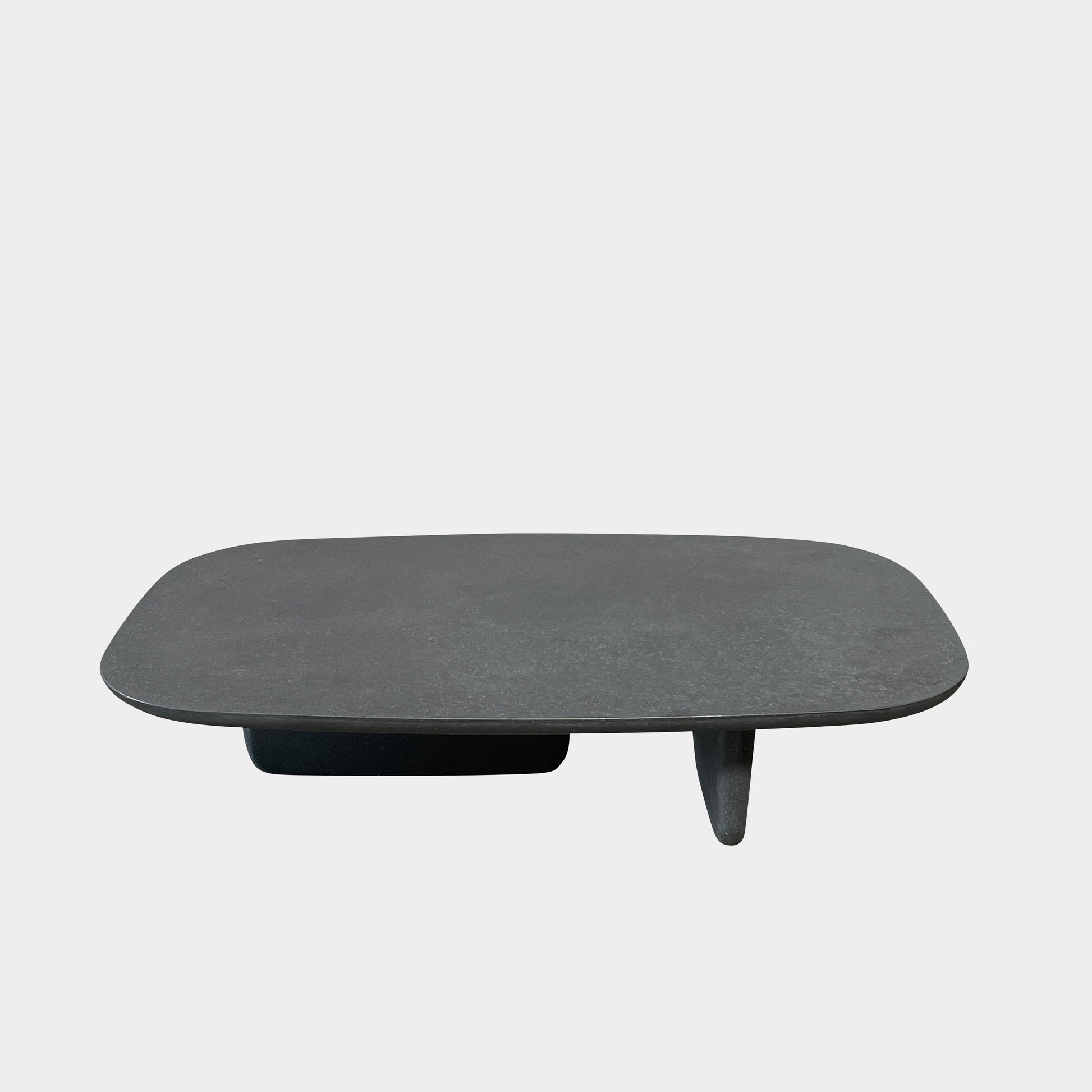 A rectangular black coffee table with asymmetrical supports on a white background, reminiscent of the B&B Italia Tobi-Ishi Outdoor Coffee Table (hold) by B&B Italia.
