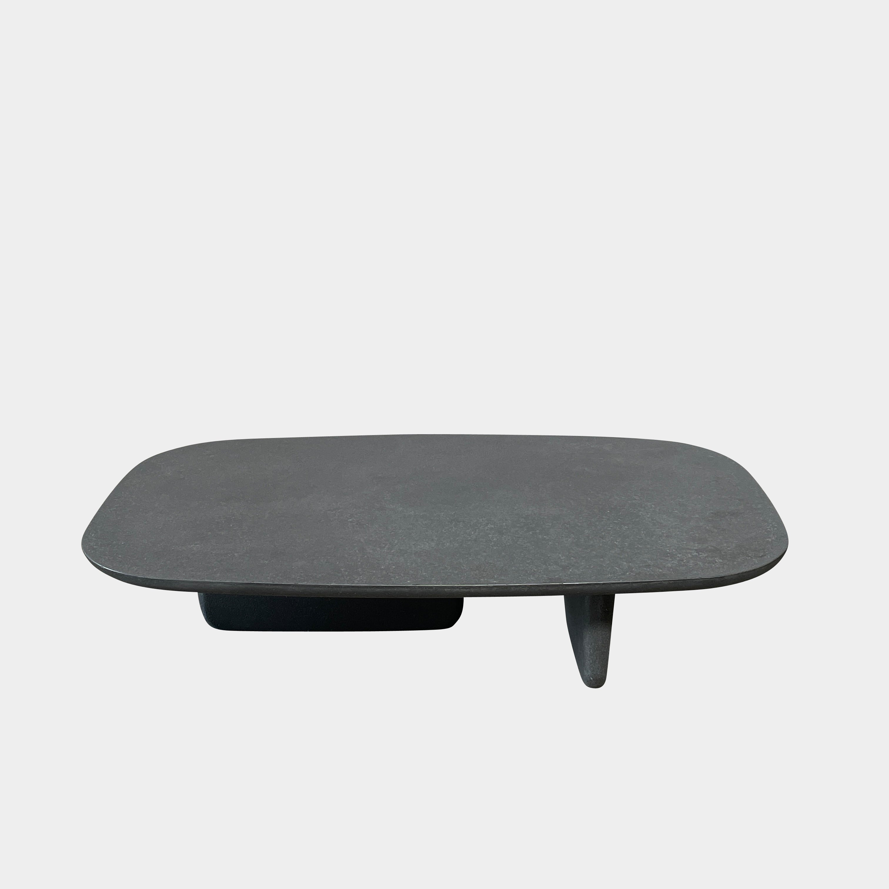 A rectangular black coffee table with asymmetrical supports on a white background, reminiscent of the B&B Italia Tobi-Ishi Outdoor Coffee Table (hold) by B&B Italia.