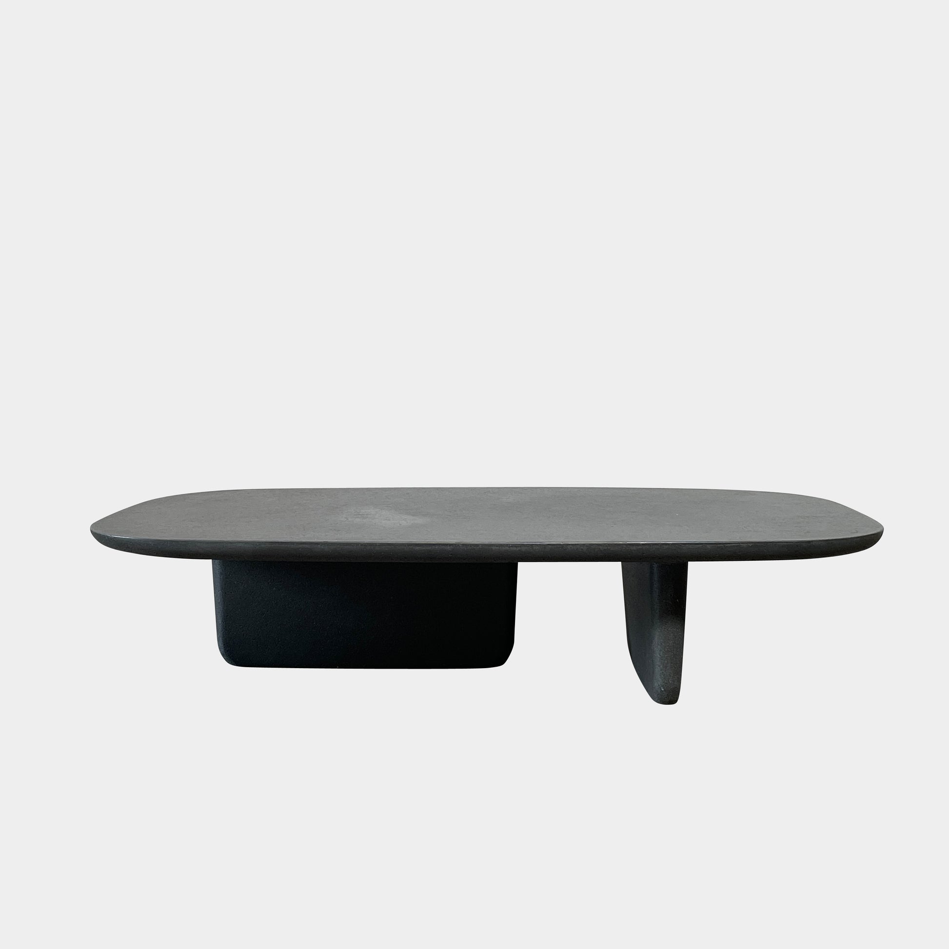 A rectangular black coffee table with asymmetrical supports on a white background, reminiscent of the B&B Italia Tobi-Ishi Outdoor Coffee Table (hold) by B&B Italia.