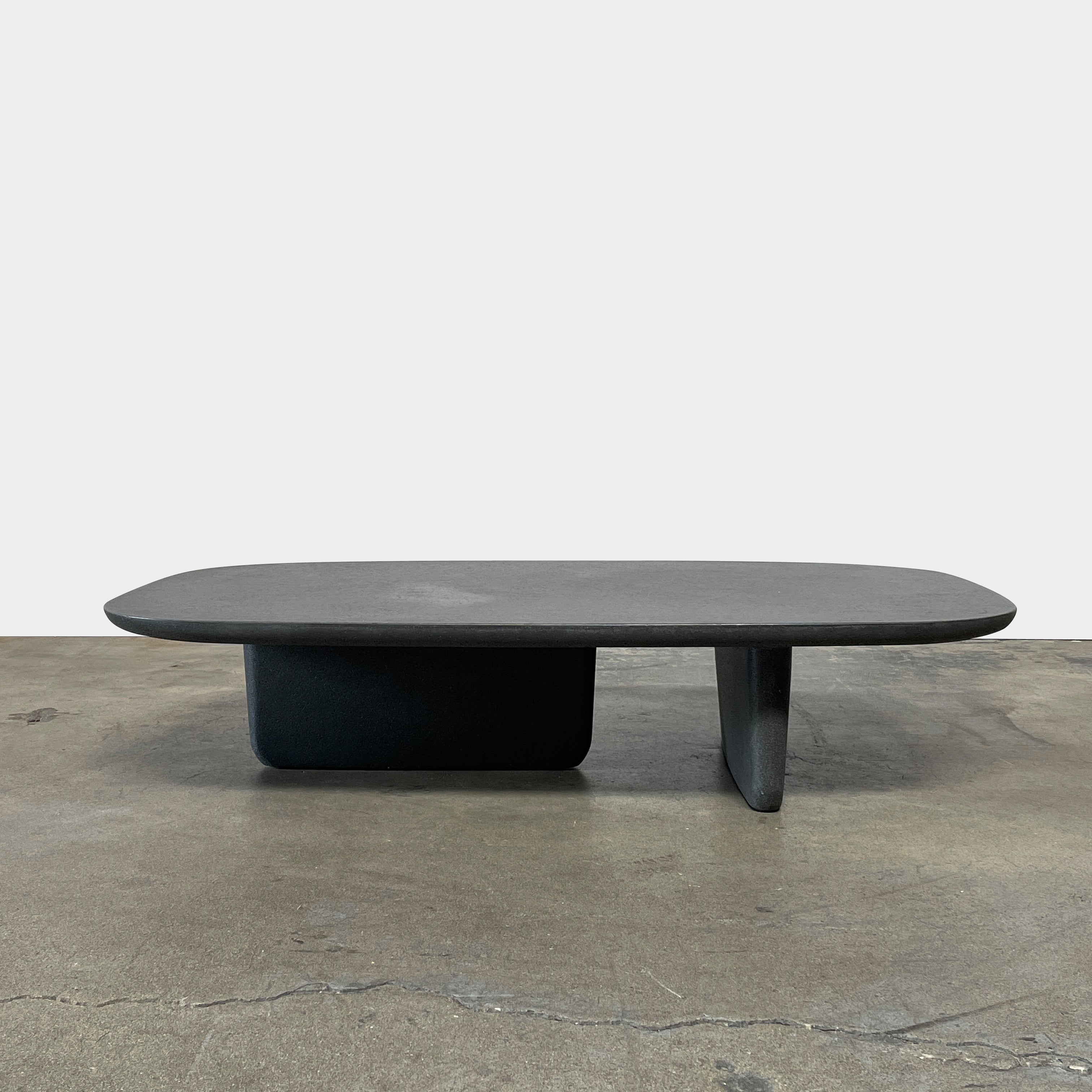 A rectangular black coffee table with asymmetrical supports on a white background, reminiscent of the B&B Italia Tobi-Ishi Outdoor Coffee Table (hold) by B&B Italia.