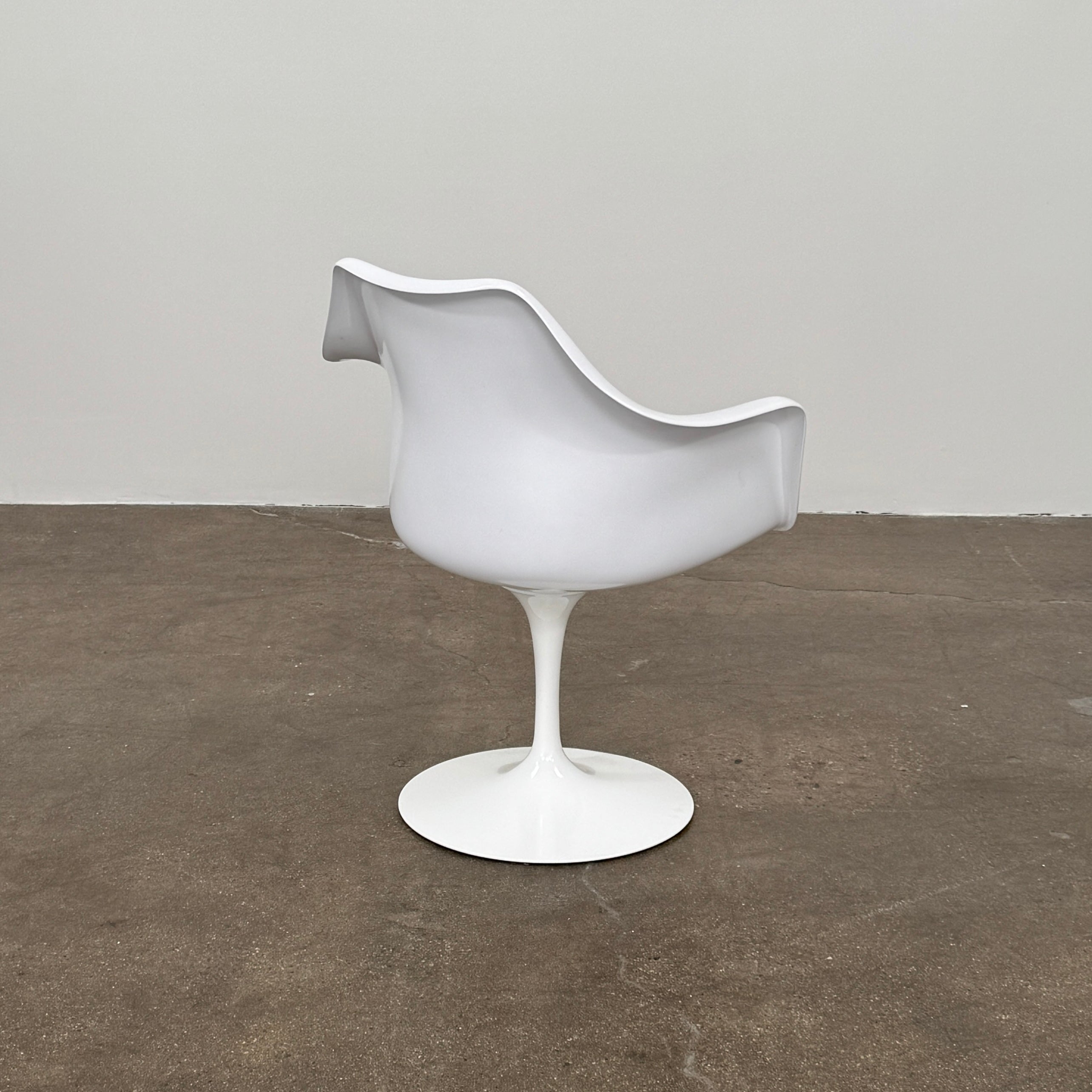 Four Knoll Saarinen Tulip Armchairs with brown vinyl seat cushions and pedestal bases, by Knoll, are arranged on a plain white background.