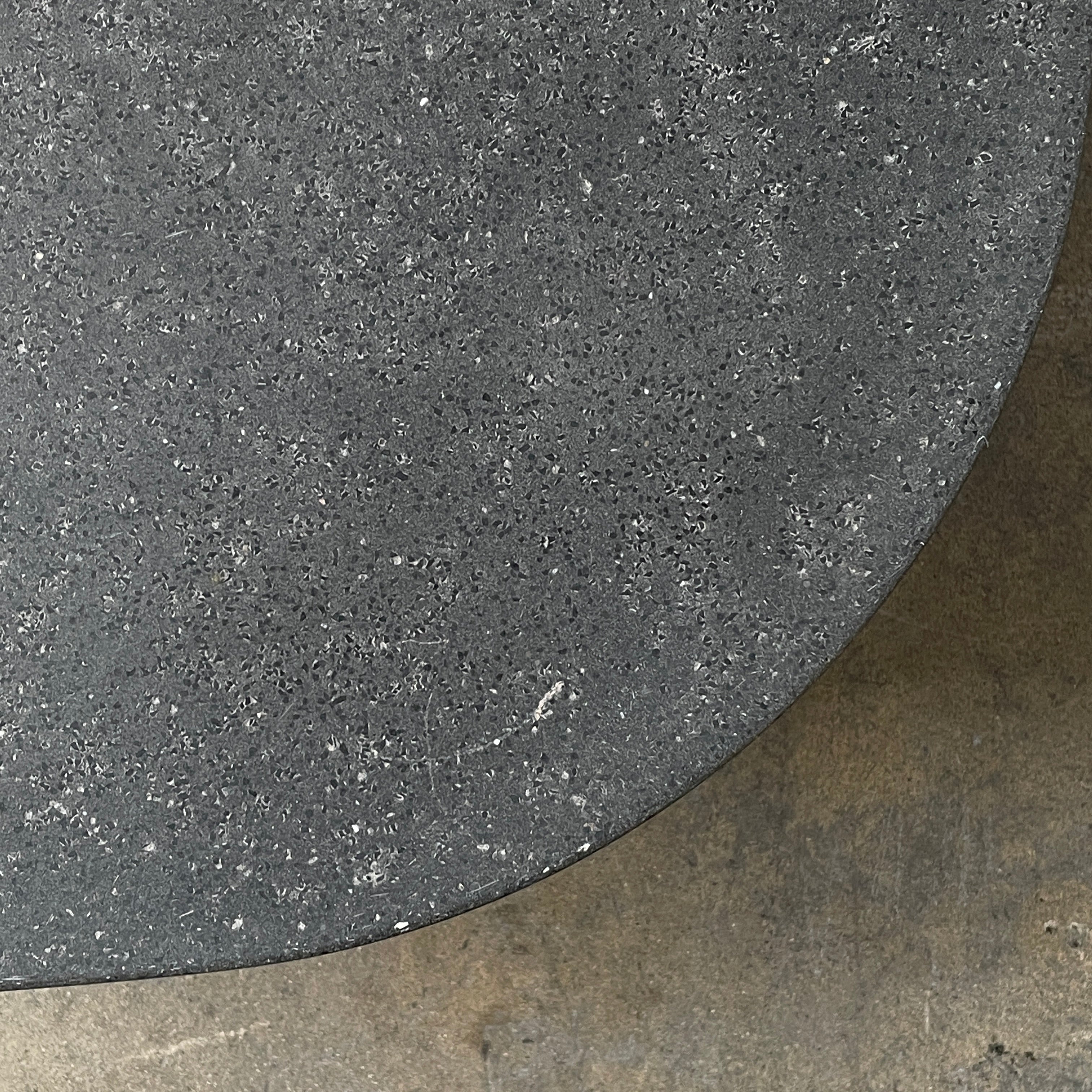 A rectangular black coffee table with asymmetrical supports on a white background, reminiscent of the B&B Italia Tobi-Ishi Outdoor Coffee Table (hold) by B&B Italia.