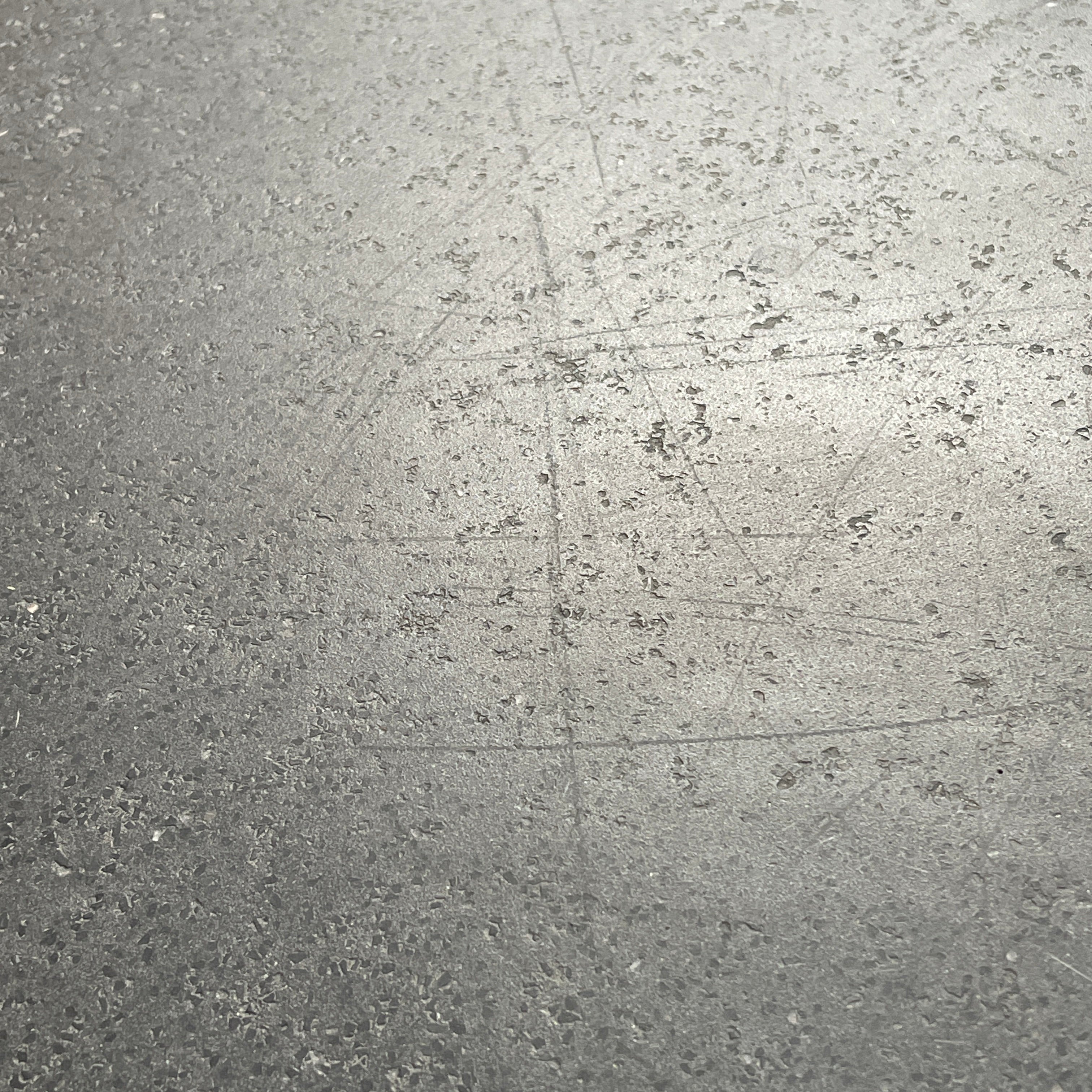 A rectangular black coffee table with asymmetrical supports on a white background, reminiscent of the B&B Italia Tobi-Ishi Outdoor Coffee Table (hold) by B&B Italia.