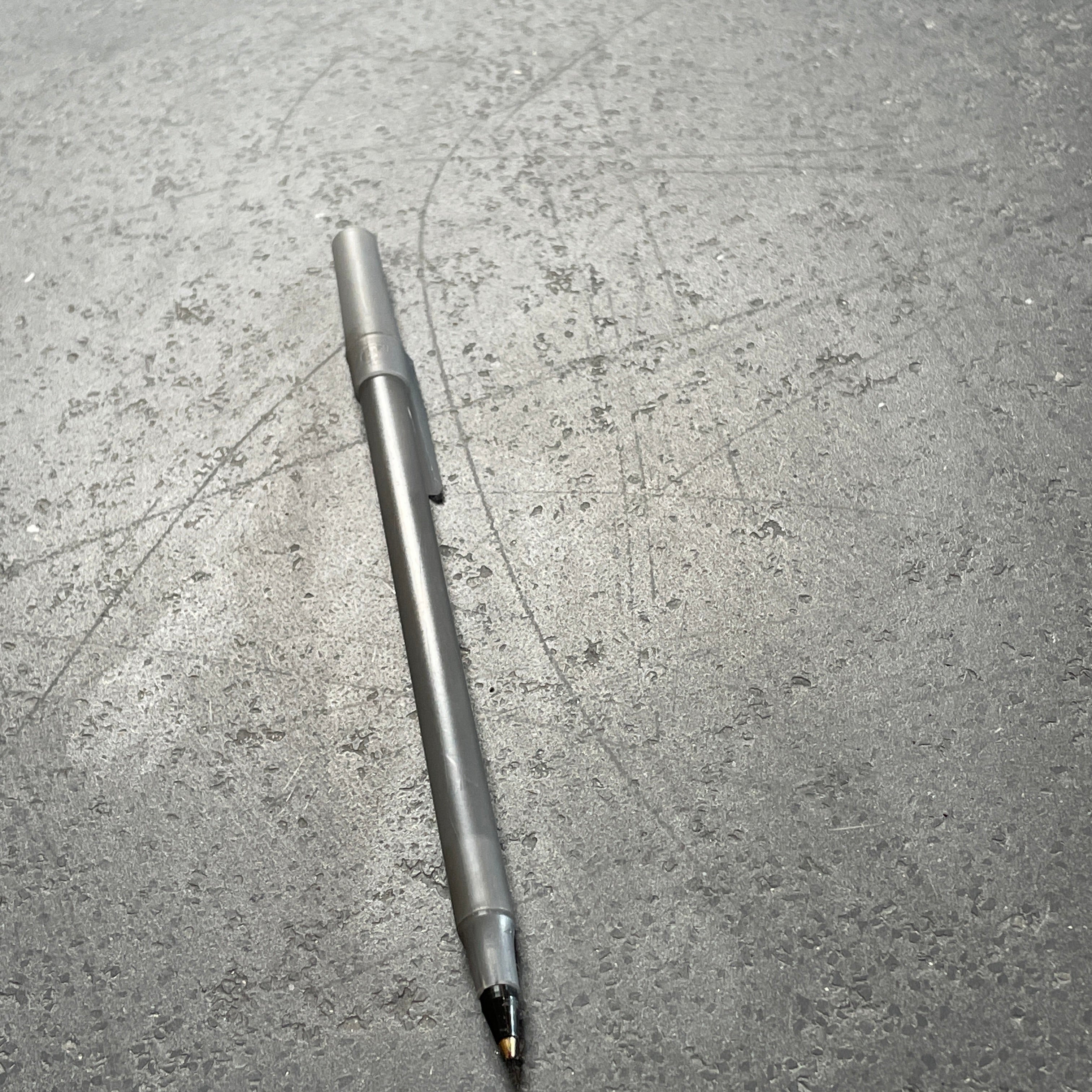 A rectangular black coffee table with asymmetrical supports on a white background, reminiscent of the B&B Italia Tobi-Ishi Outdoor Coffee Table (hold) by B&B Italia.