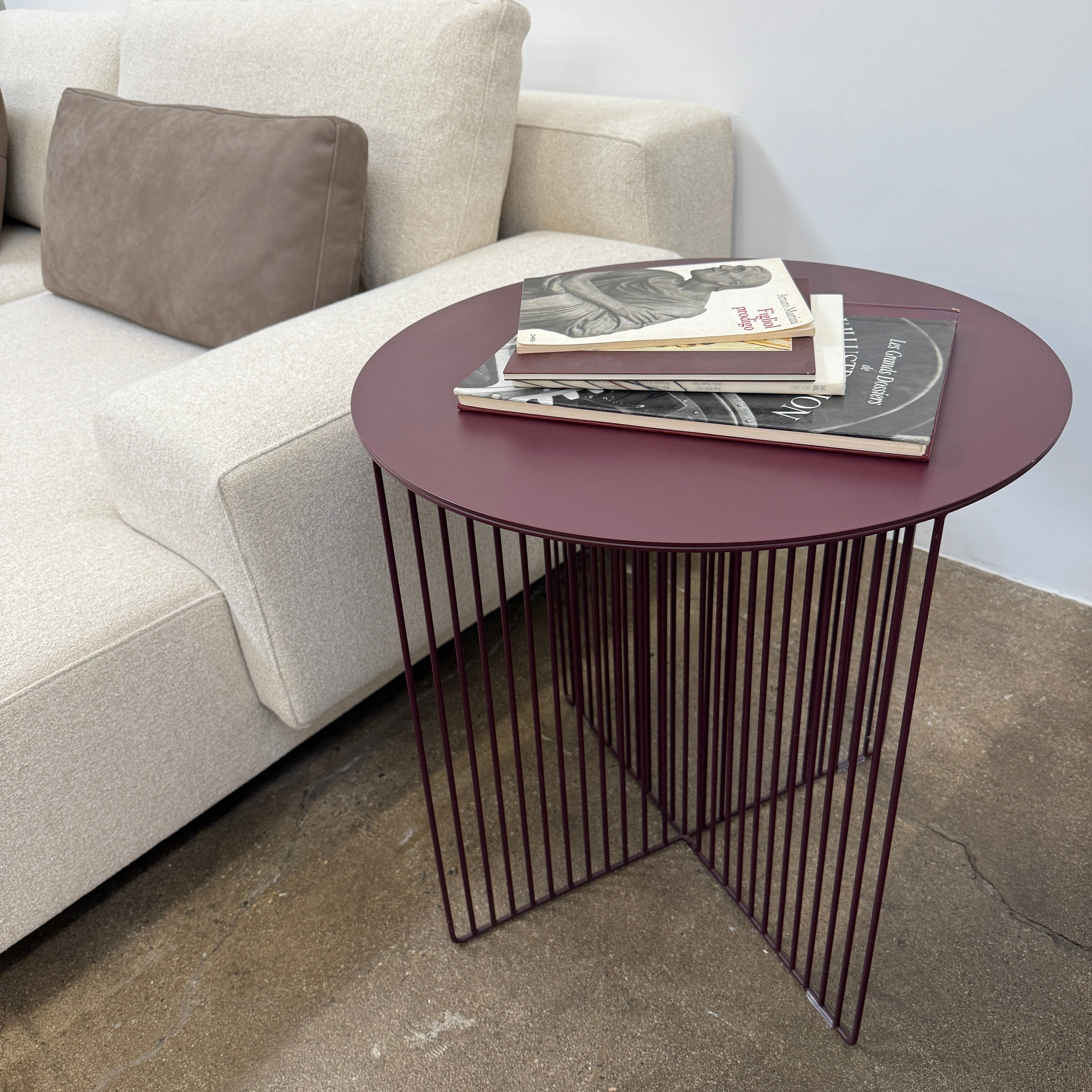The LaCividina Accursio Occasional Table by La Cividina showcases a sleek dark top and geometric base of vertical metal rods, making it ideal for contemporary spaces.