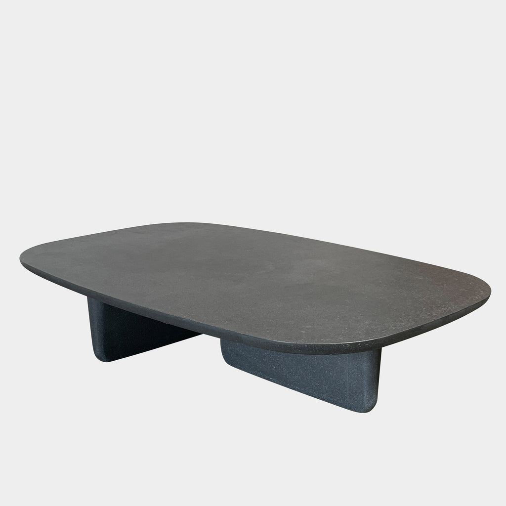 A rectangular black coffee table with asymmetrical supports on a white background, reminiscent of the B&B Italia Tobi-Ishi Outdoor Coffee Table (hold) by B&B Italia.