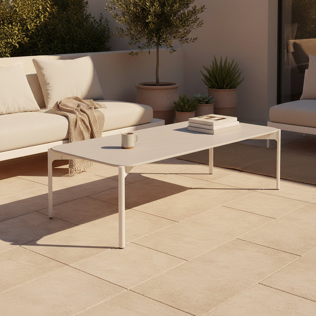 The Dedon Izon Outdoor Coffee Table by Dedon features a flat light gray surface and four slender, angled legs, delivering sleek, weather-resistant style for your outdoor space against a plain white background.