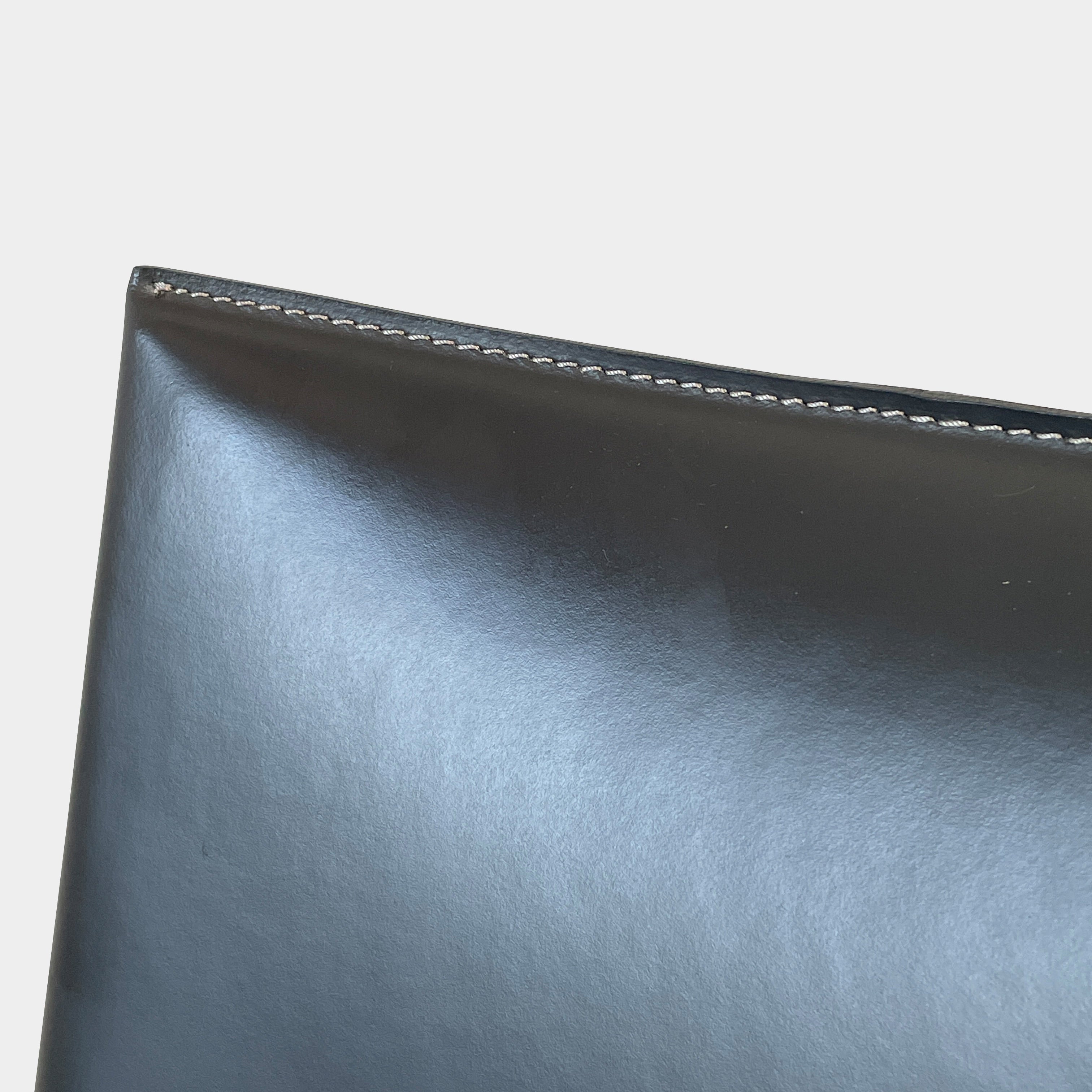 Four Frag Bella Dining Chairs in Dark Grey Leather with metal legs, arranged in a straight line against a plain white background.